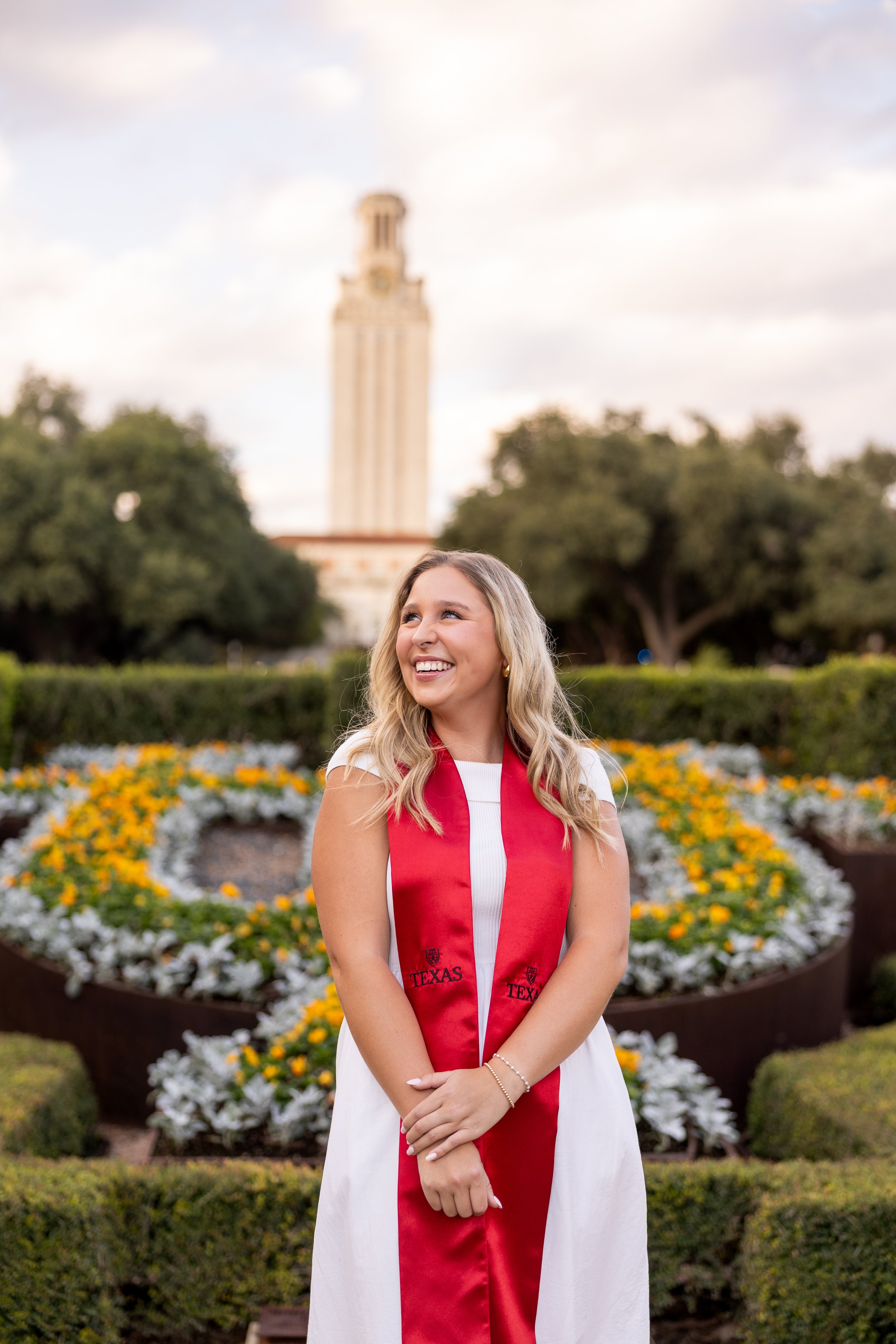 Austin senior graduation photography by Mandy Laine Photo: a college woman at a Texas university, captured in natural light for joyful, authentic graduation moments.