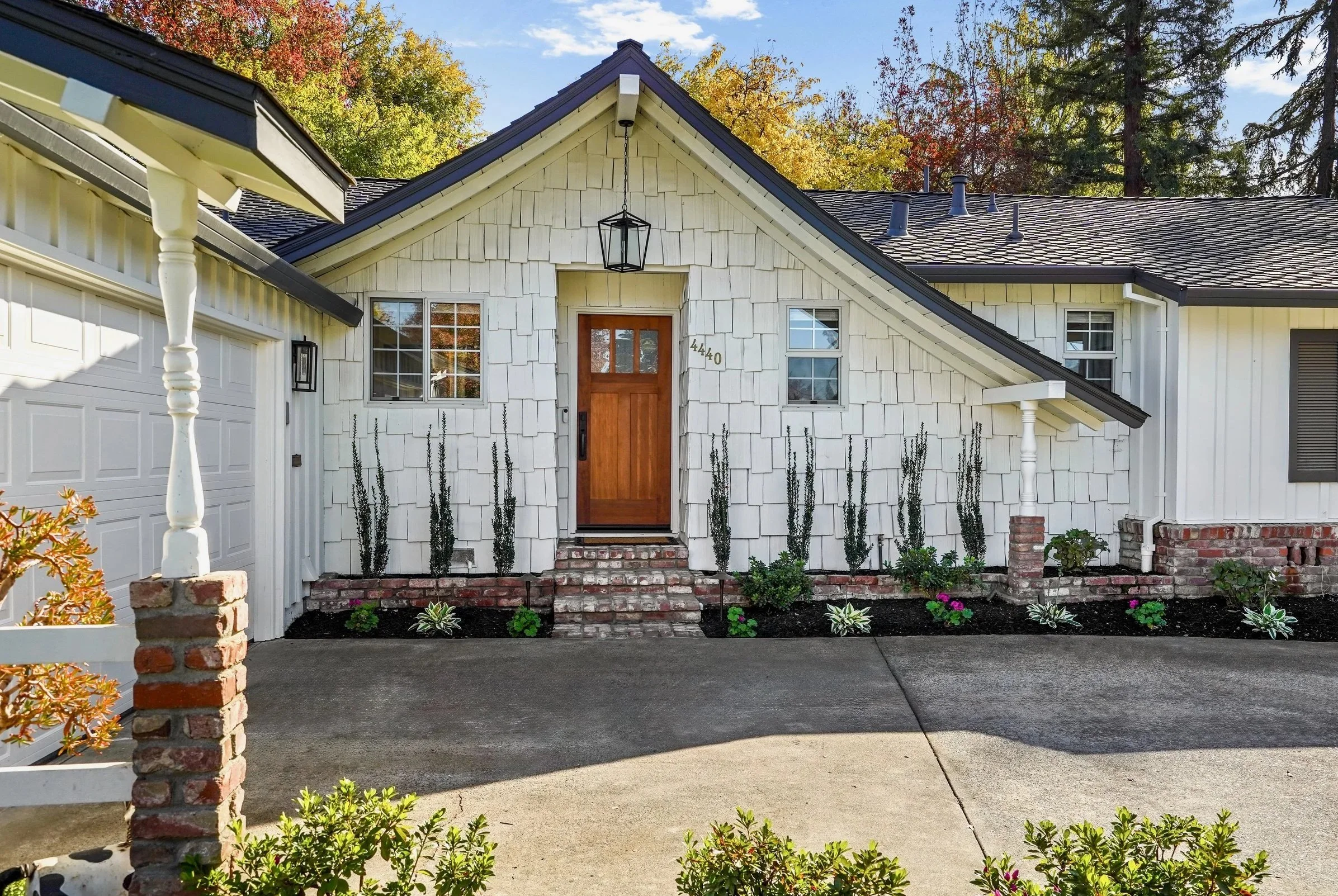 Recently renovated white house with fresh paint and new landscaping