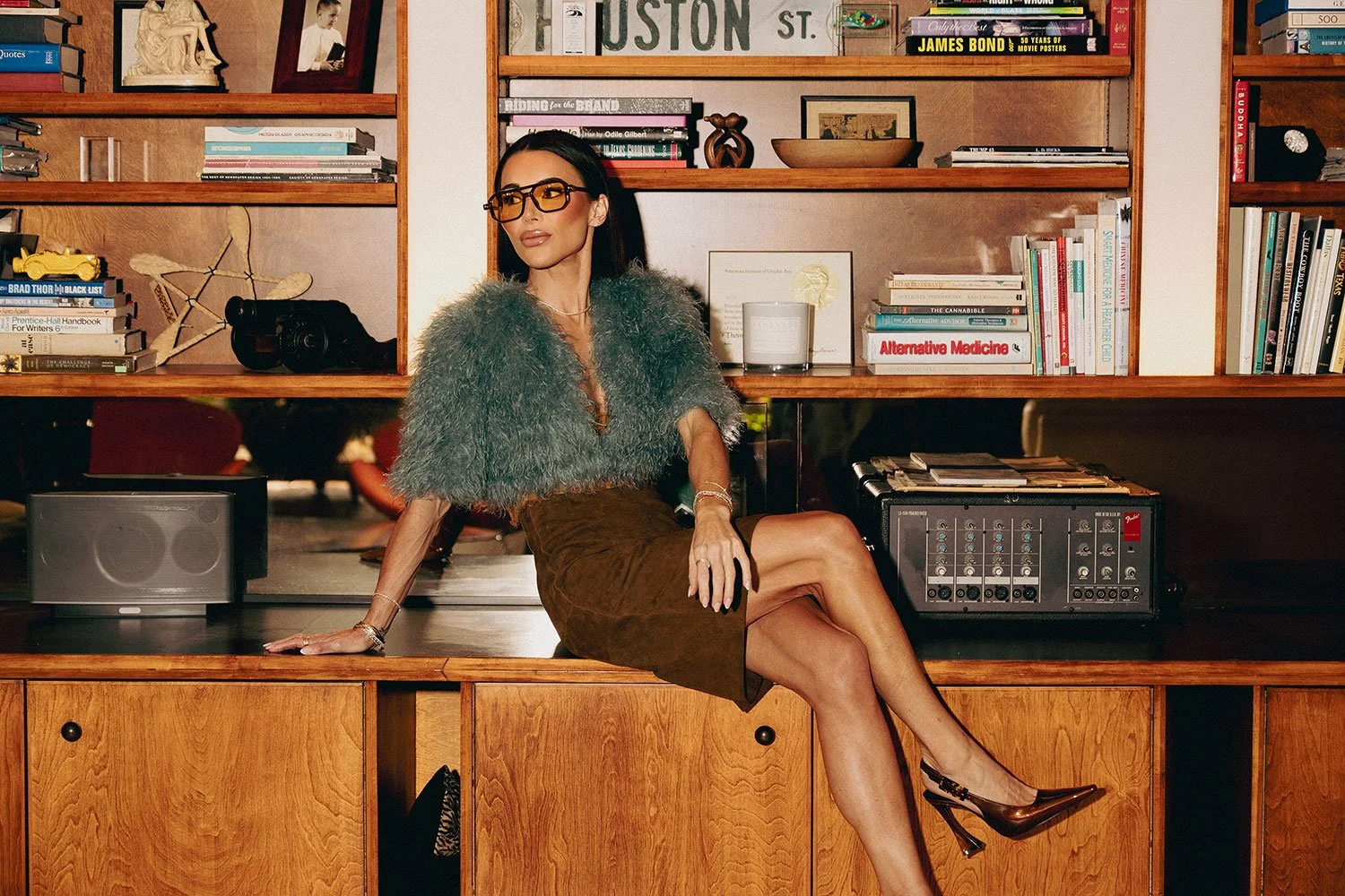 Interior designer Danielle Harbeck standing in a high-end multifamily apartment amenity space featuring bespoke architectural finishes and modern lighting