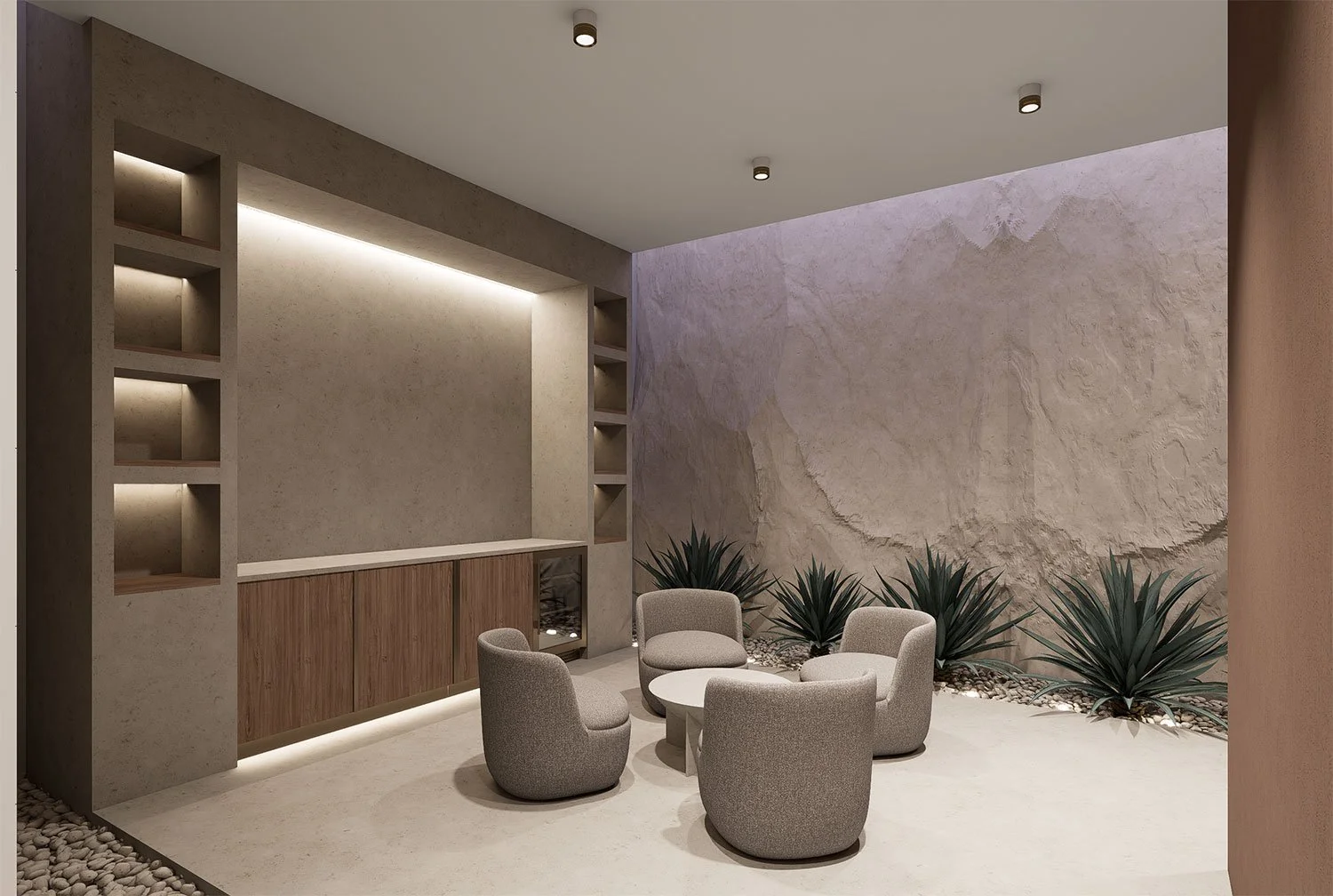 A modern outdoor patio with four beige armchairs arranged around a small round table, set against a textured rock wall with large green plants and pebbles at the base, under ceiling lighting.