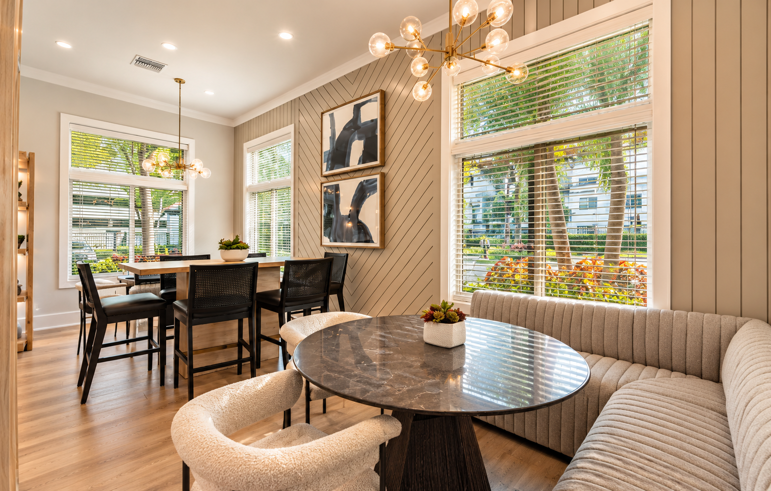 Sunlit Modern Dining Nook with Brass Chandeliers.png