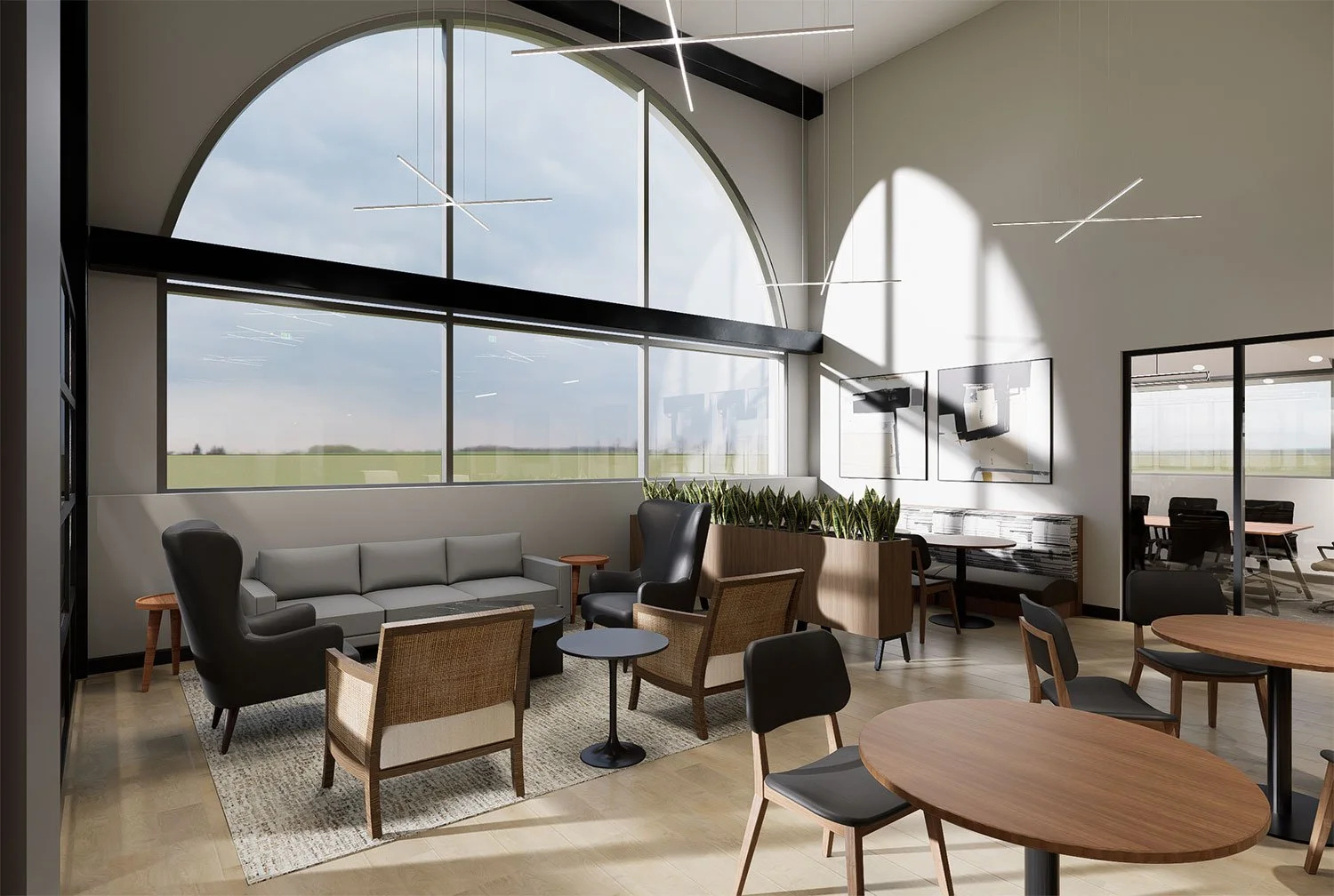 Modern lounge area with large windows, grey sofa, black and wooden armchairs, coffee tables, and a TV on the wall.