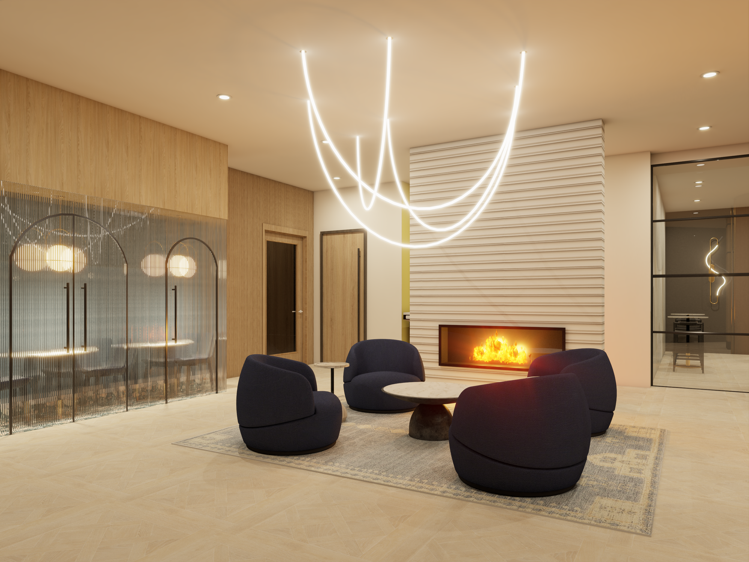 Modern living room with navy blue lounge chairs, a round marble-topped coffee table, a fireplace, and artistic light fixtures.
