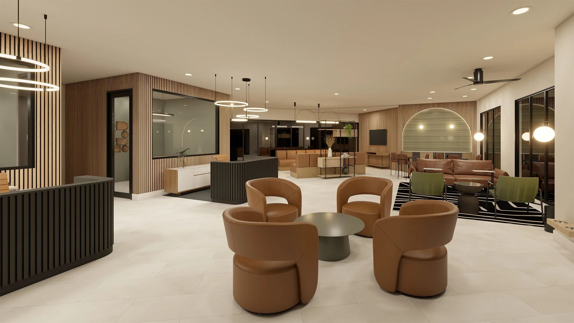 Modern hotel lobby with tan and brown furniture, black and wooden accents, and large windows. There are circular chairs around a small black table, a sitting area with sofas, and decorative lighting fixtures.
