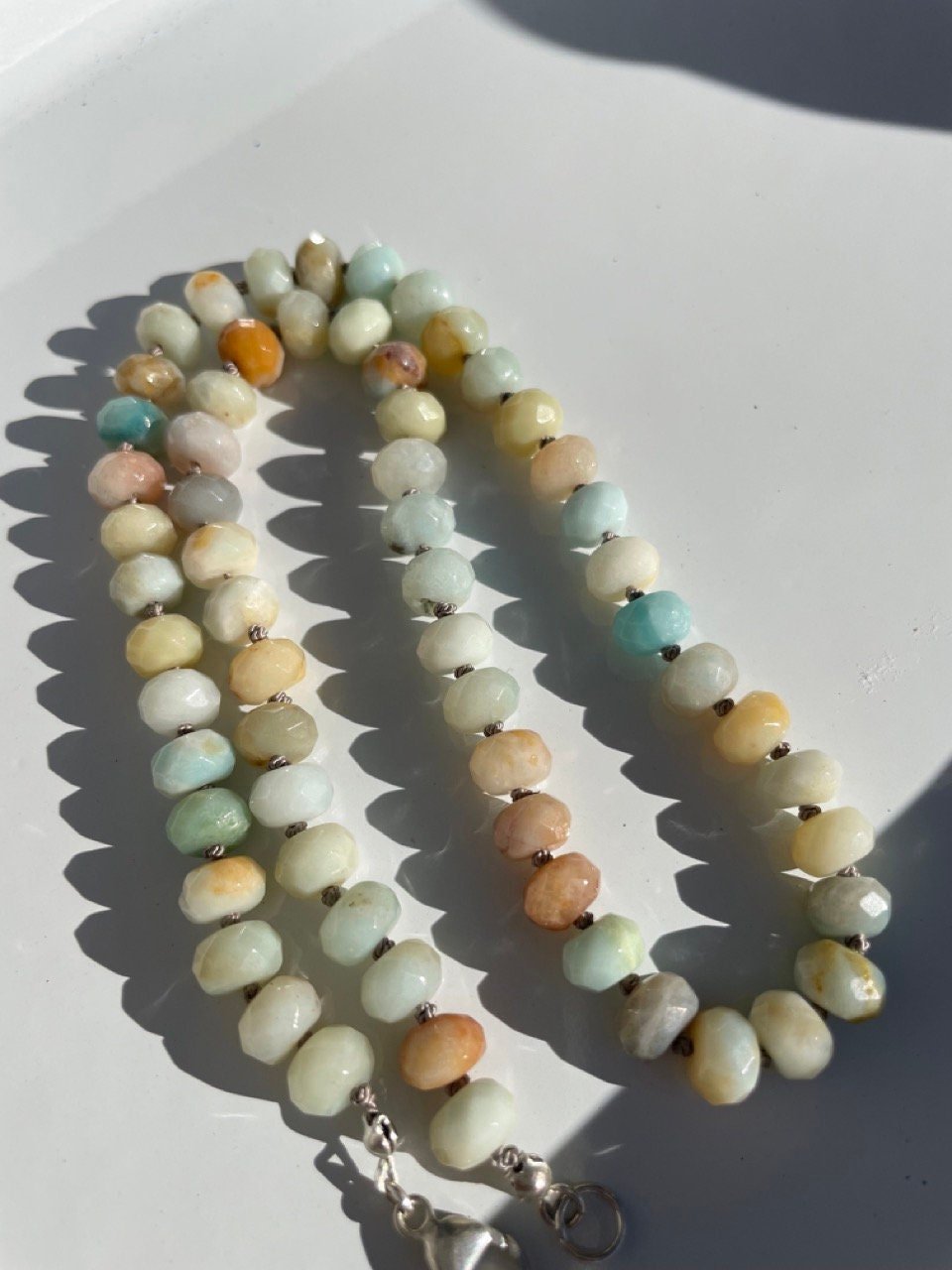 zoomed in picture of necklace made of semiprecious gemstone mixed amazonite hand knotted with silk thread