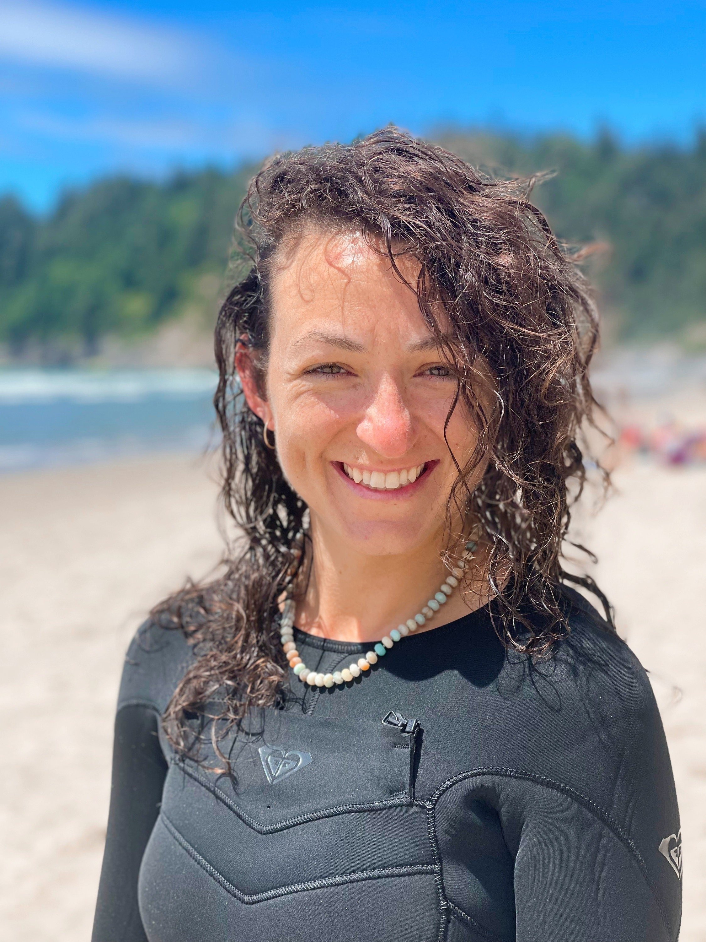 woman at the beach wearing necklace made of semiprecious gemstone mixed amazonite hand knotted with silk thread