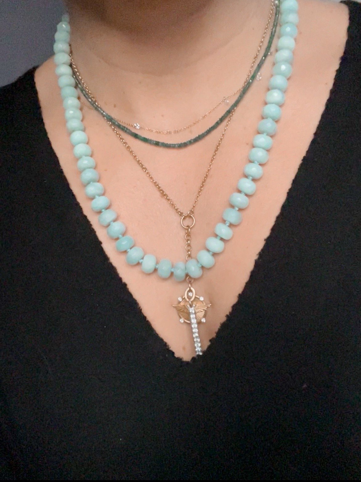 woman wearing handmade necklace of semiprecious amazonite stones with silk thread knotted