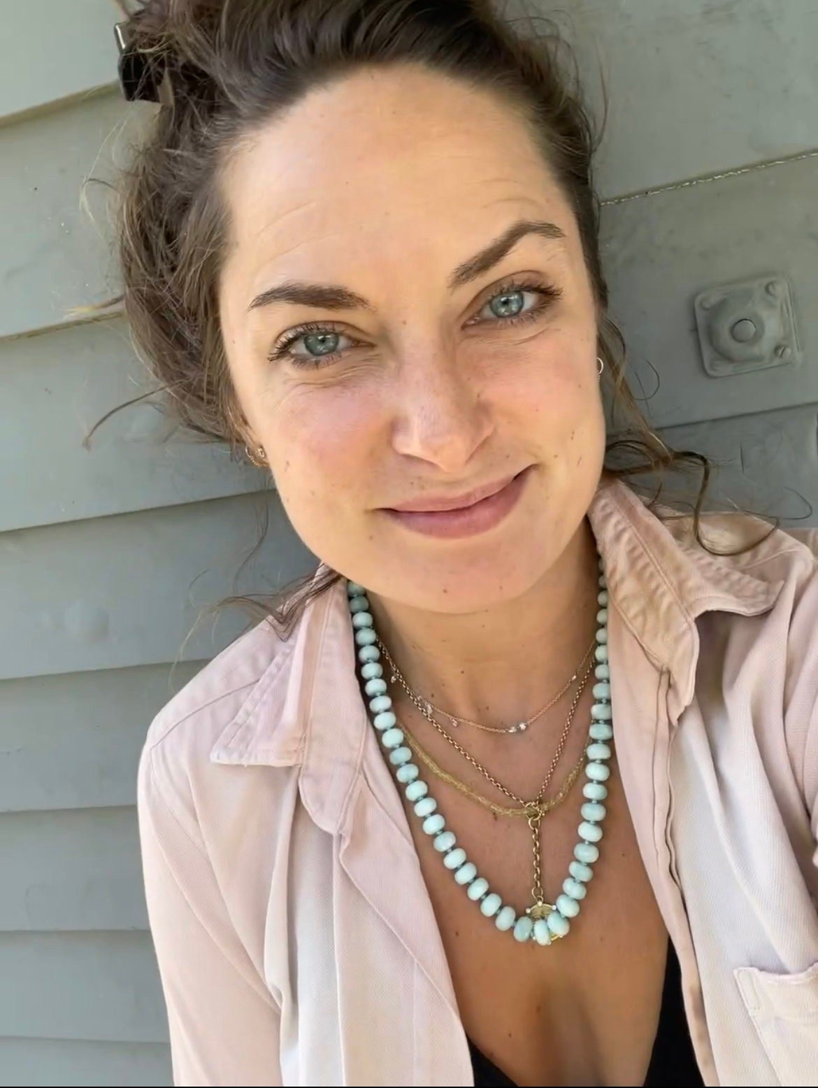 woman wearing handmade necklace of semiprecious amazonite stones with silk thread knotted
