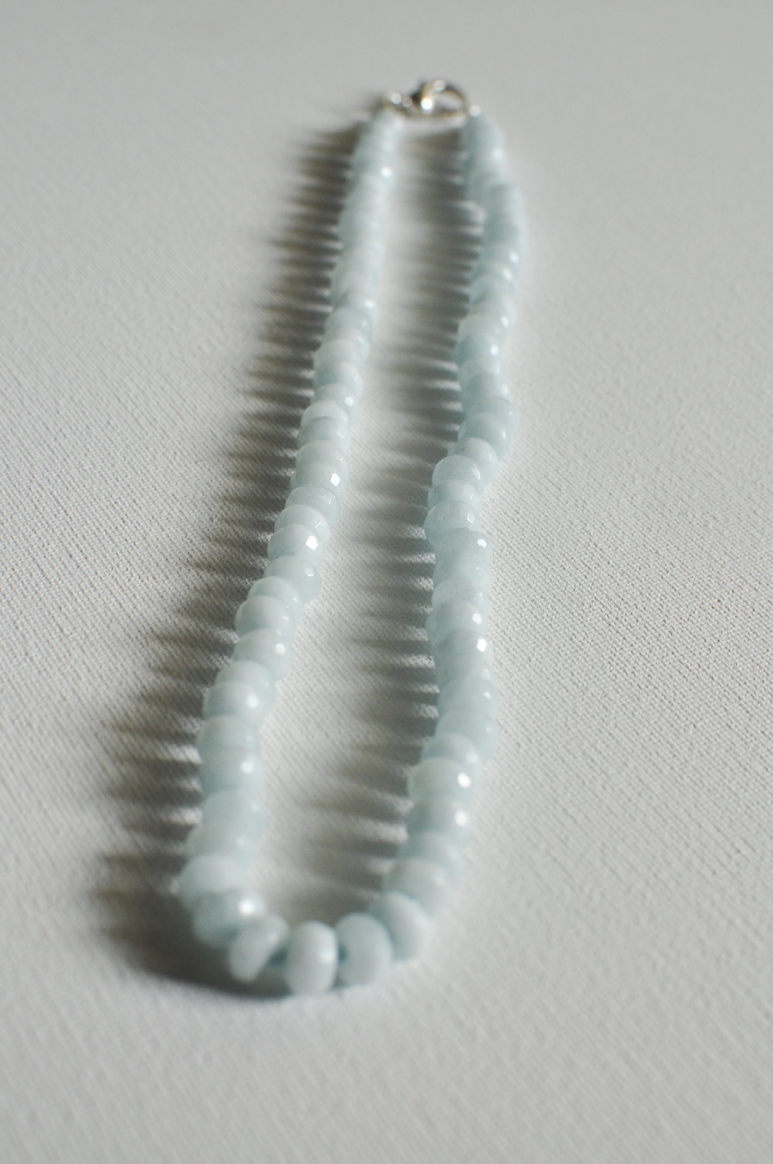 handmade necklace of semiprecious gemstone aquamarine knotted on silk thread