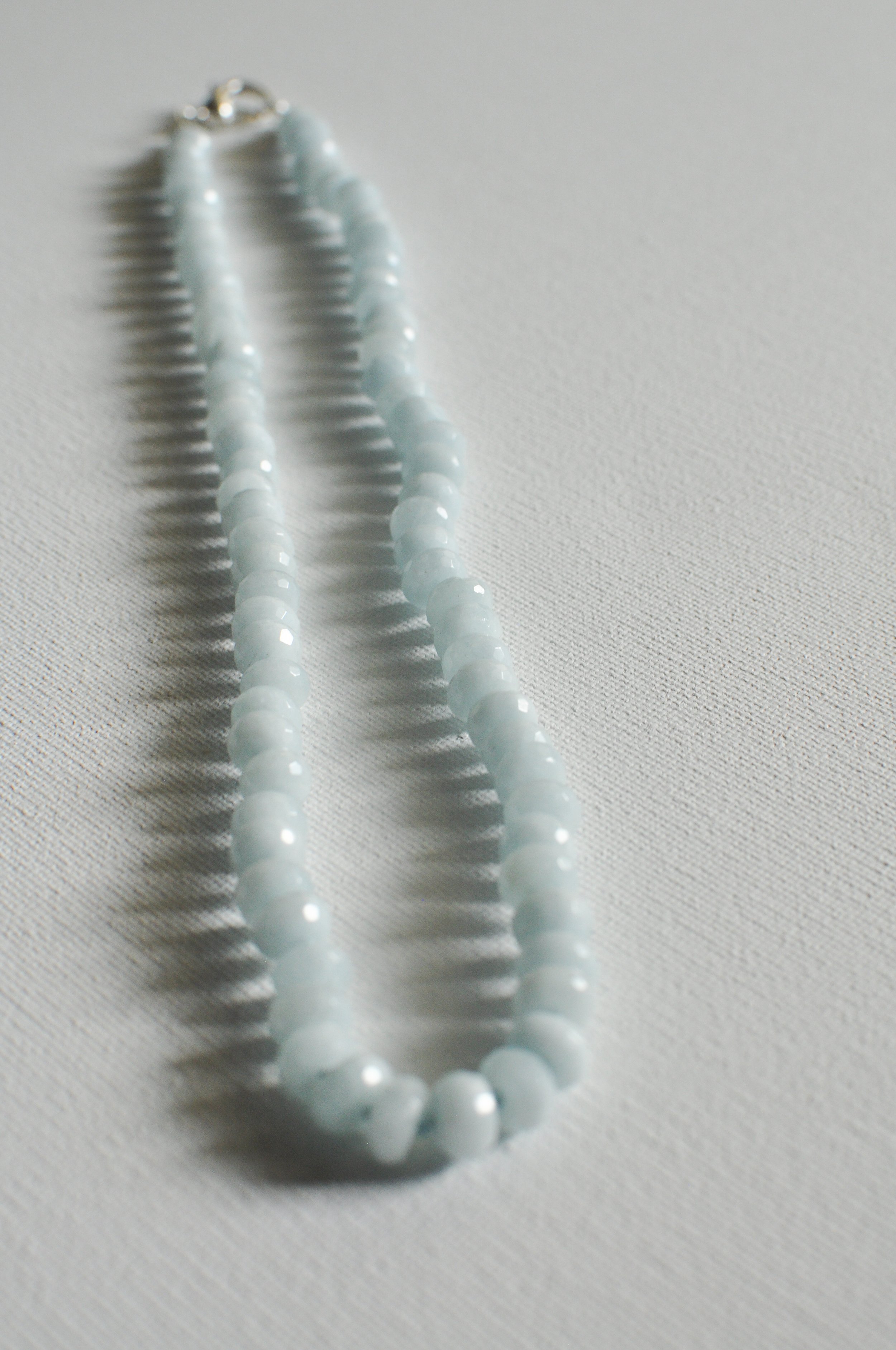 handmade necklace of semiprecious gemstone aquamarine knotted on silk thread