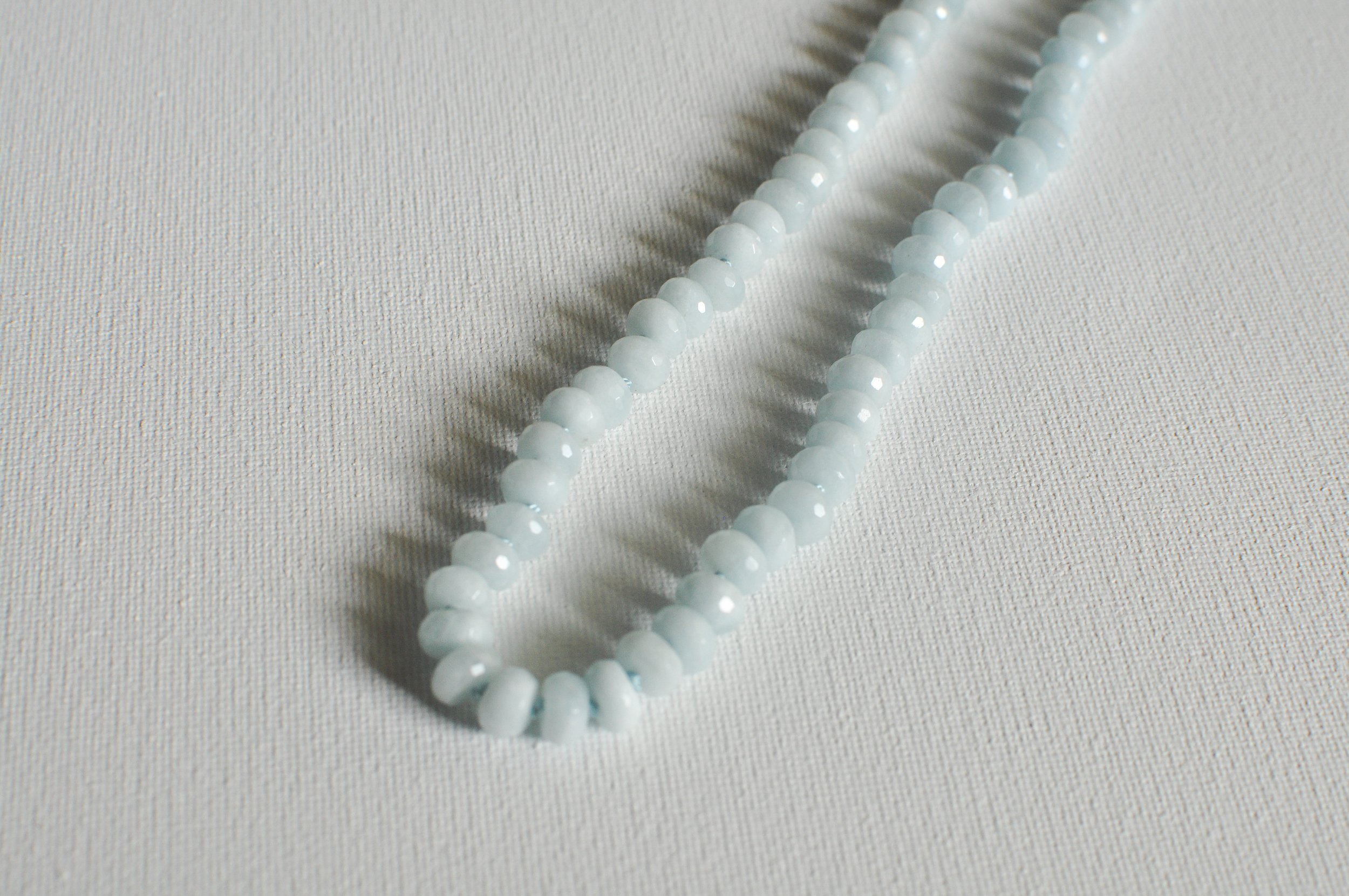 handmade necklace of semiprecious gemstone aquamarine knotted on silk thread