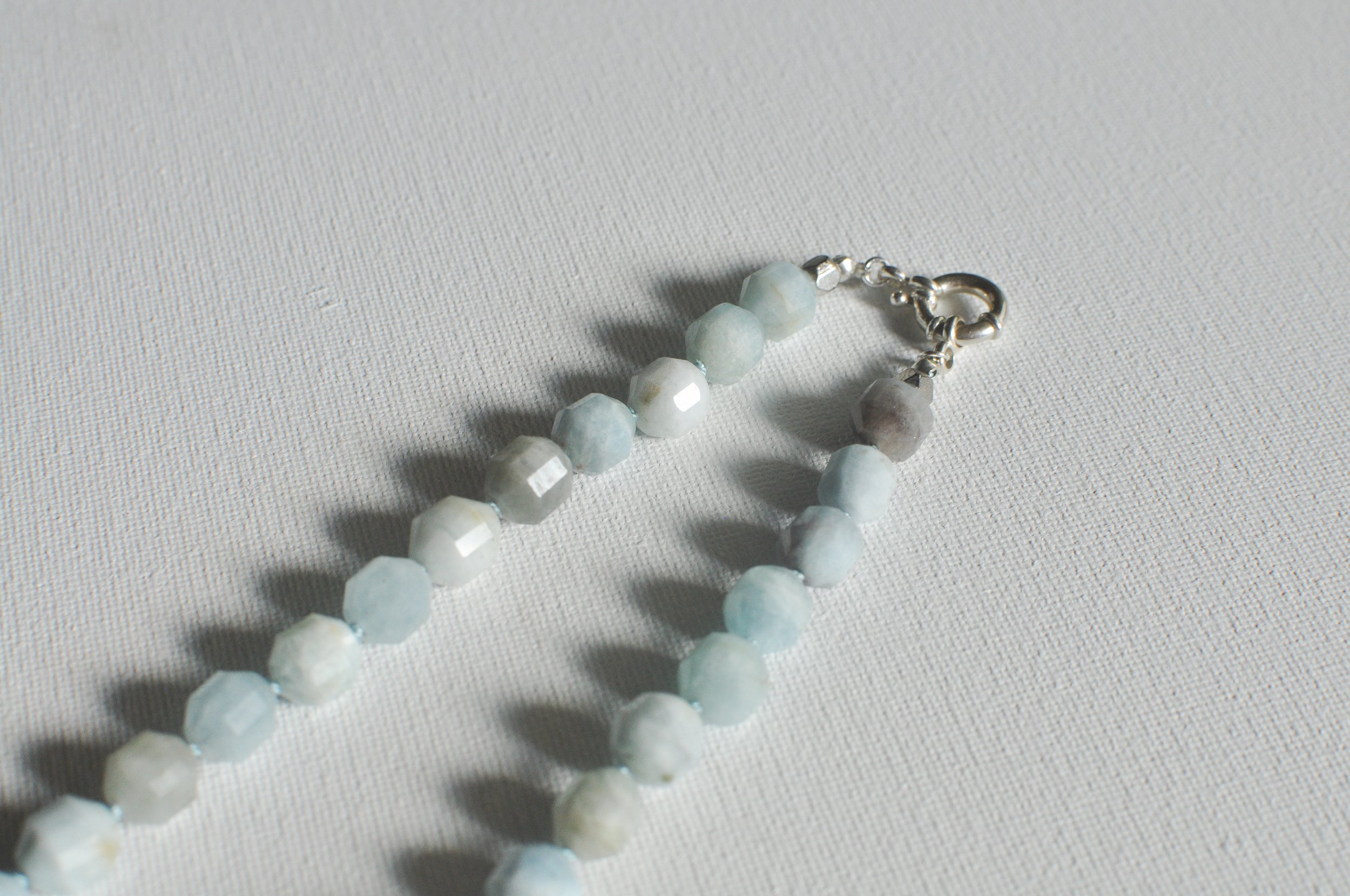 handmade necklace of semiprecious gemstone aquamarine knotted on silk thread with sterling silver clasp