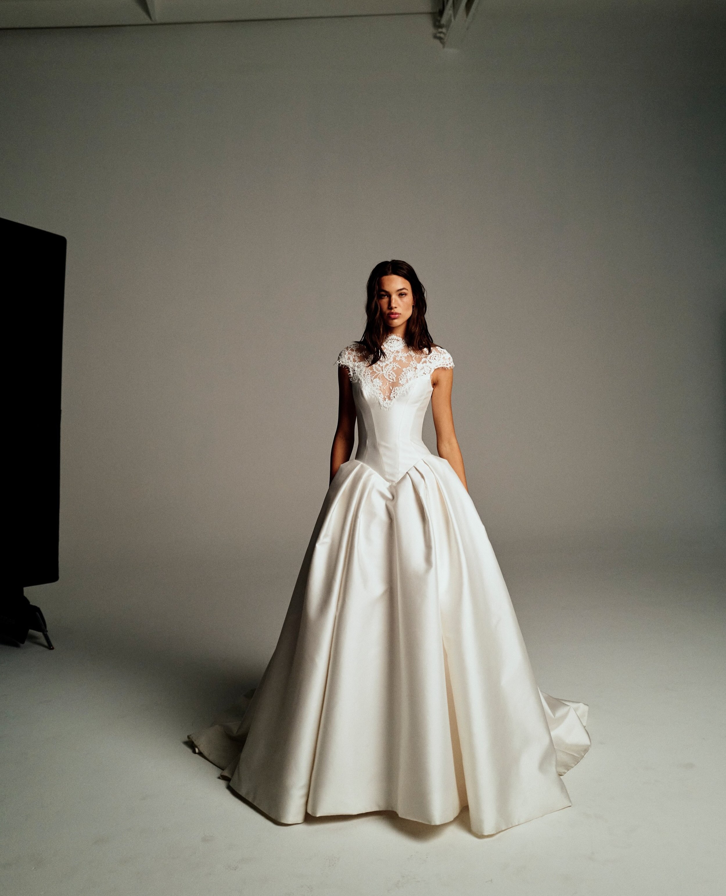 New Arrival from @moniquelhuillierbride. Spencer, a corseted basque waist ball gown with high neck cap sleeve neckline in Mikado and re-embroidered lace. Book your private appointment now to be one of the first to try Spencer in the boutique.