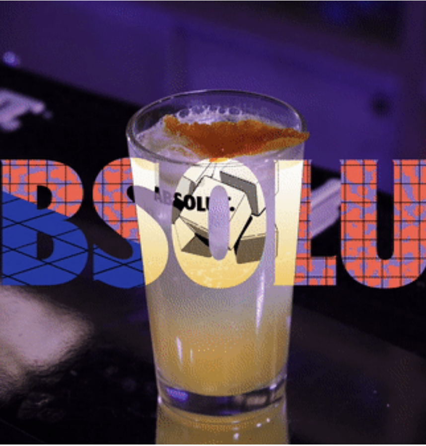 A cocktail with a slice of orange on the rim, in a tall glass, on a dark surface with colorful text overlay.