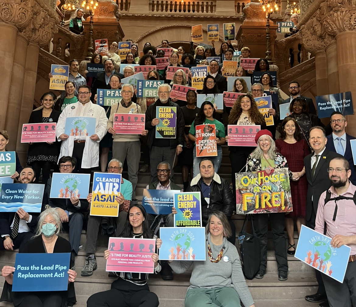 Advocates holding signs at the Million Dollar Staircase in the Capitol on Earth Day Advocacy Day 2026