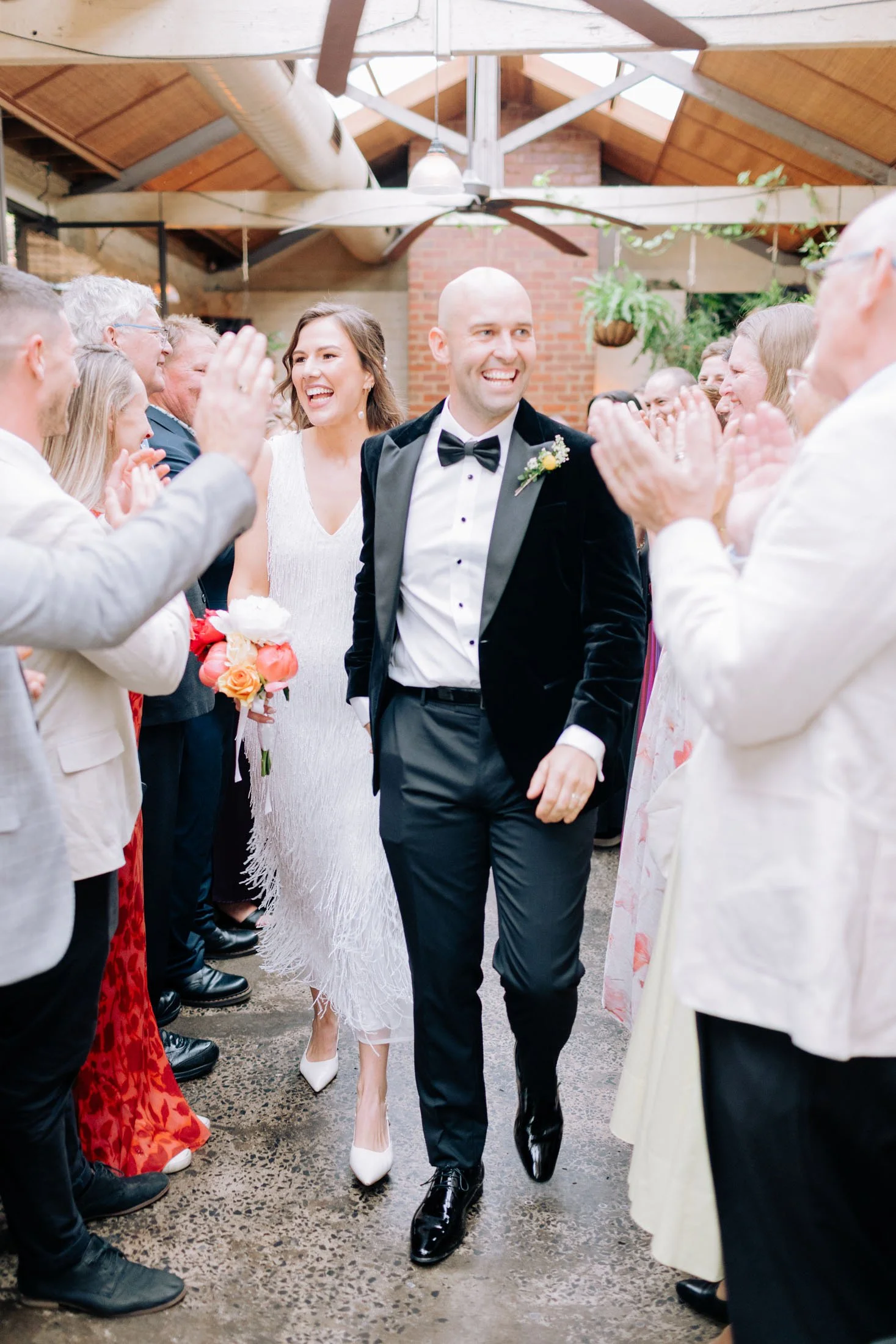 Simple Melbourne wedding ceremony at Old Palm Liquor Brunswick with celebrant Kate Mac as the couple walk back down the aisle surrounded by cheering guests