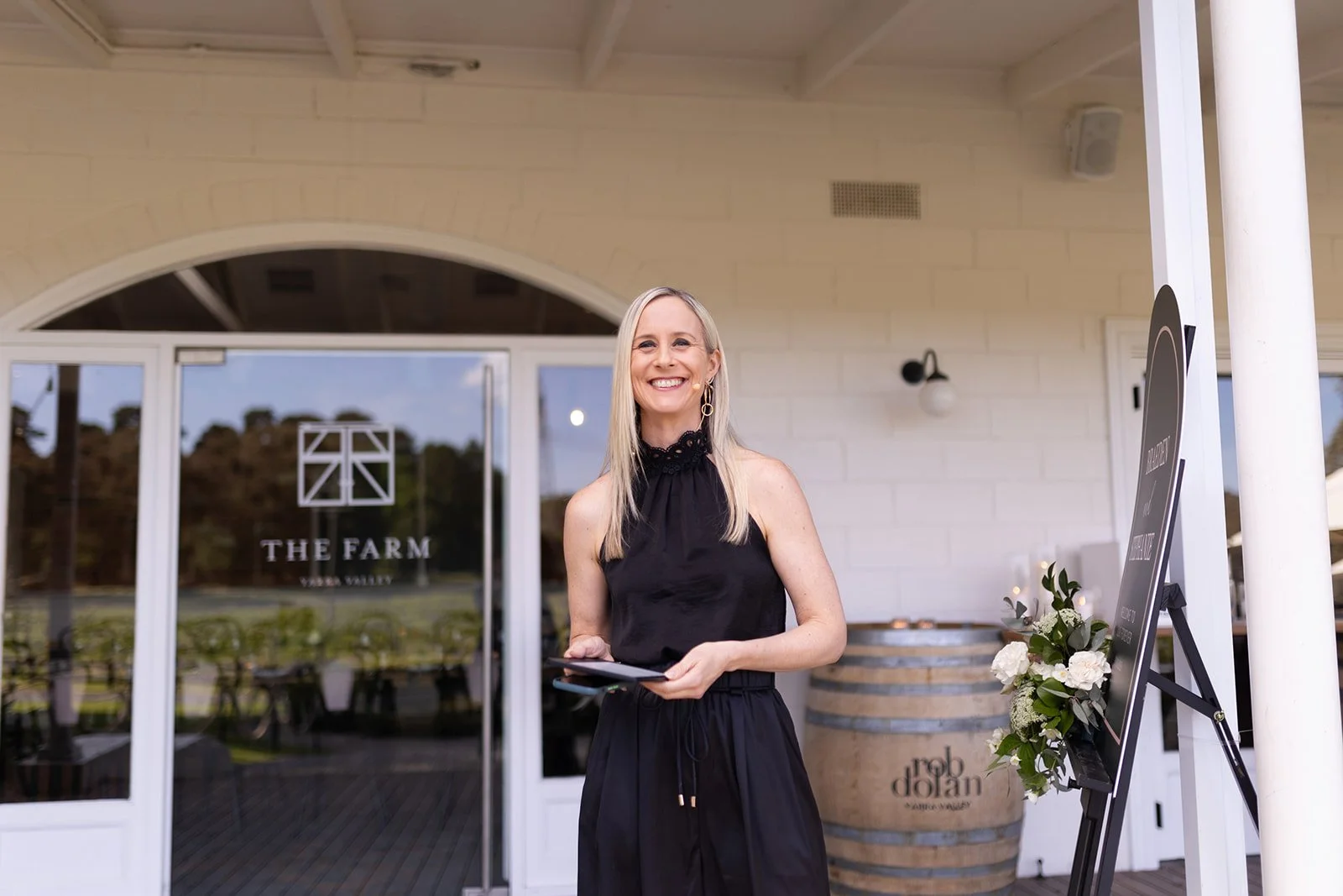Melbourne celebrant Kate Mac at The Farm in the Yarra Valley preparing for a wedding ceremony with headset microphone and ceremony script