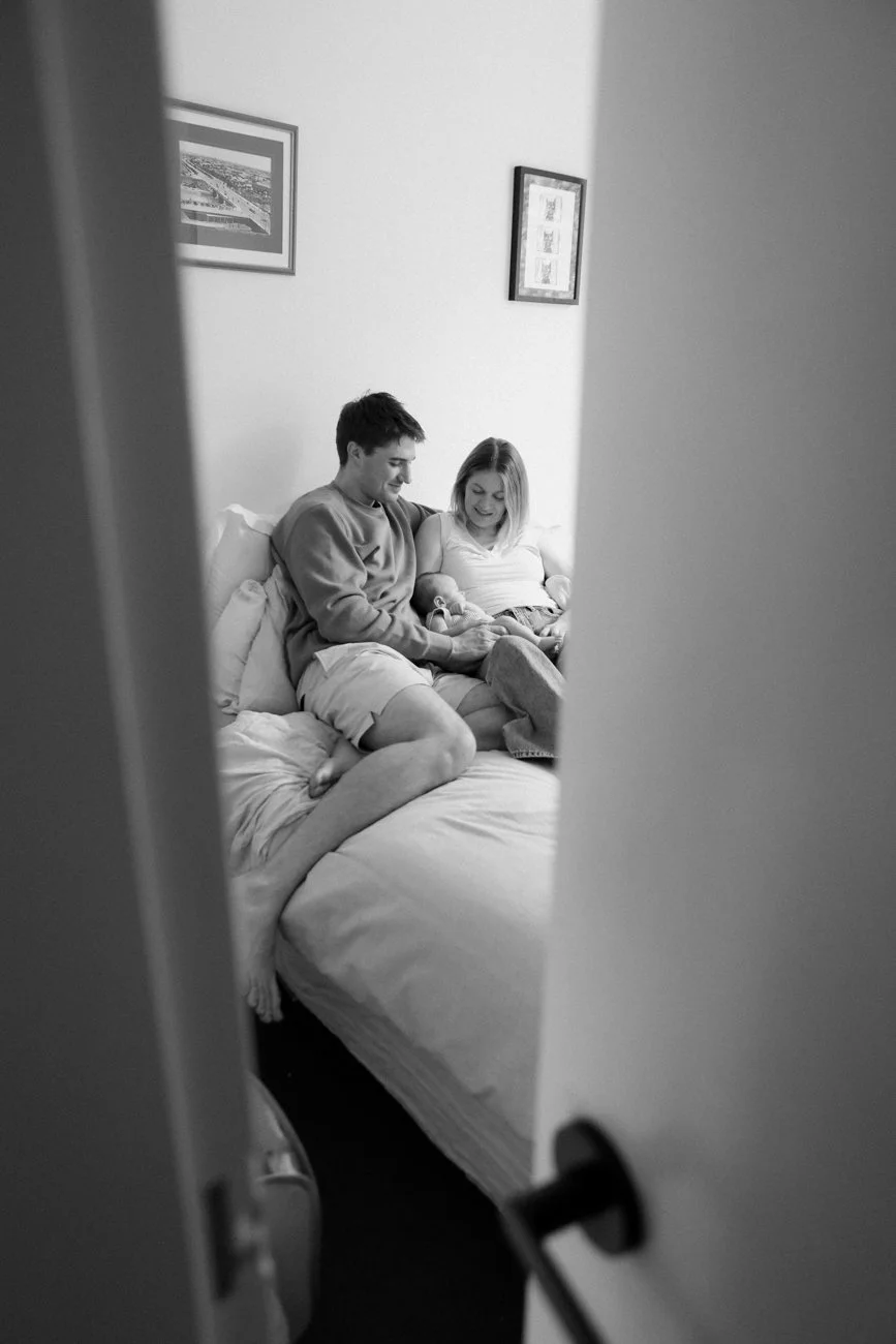 family-portraiture-mother-father-with-newborn-on-bed.001.jpg