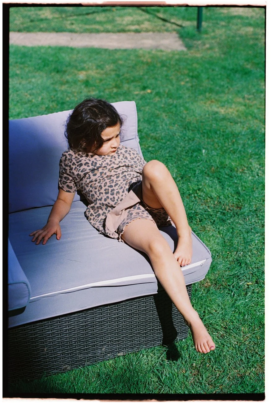 family-portraiture-young-girl-on-chair-outside.001.jpg