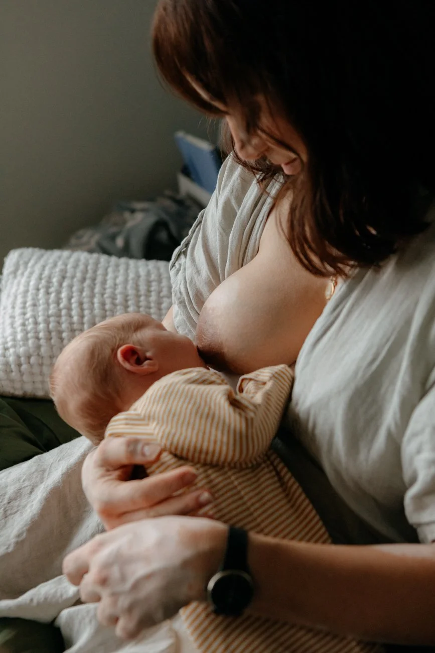family-portraiture-mother-feeding-on-bed.001.jpg