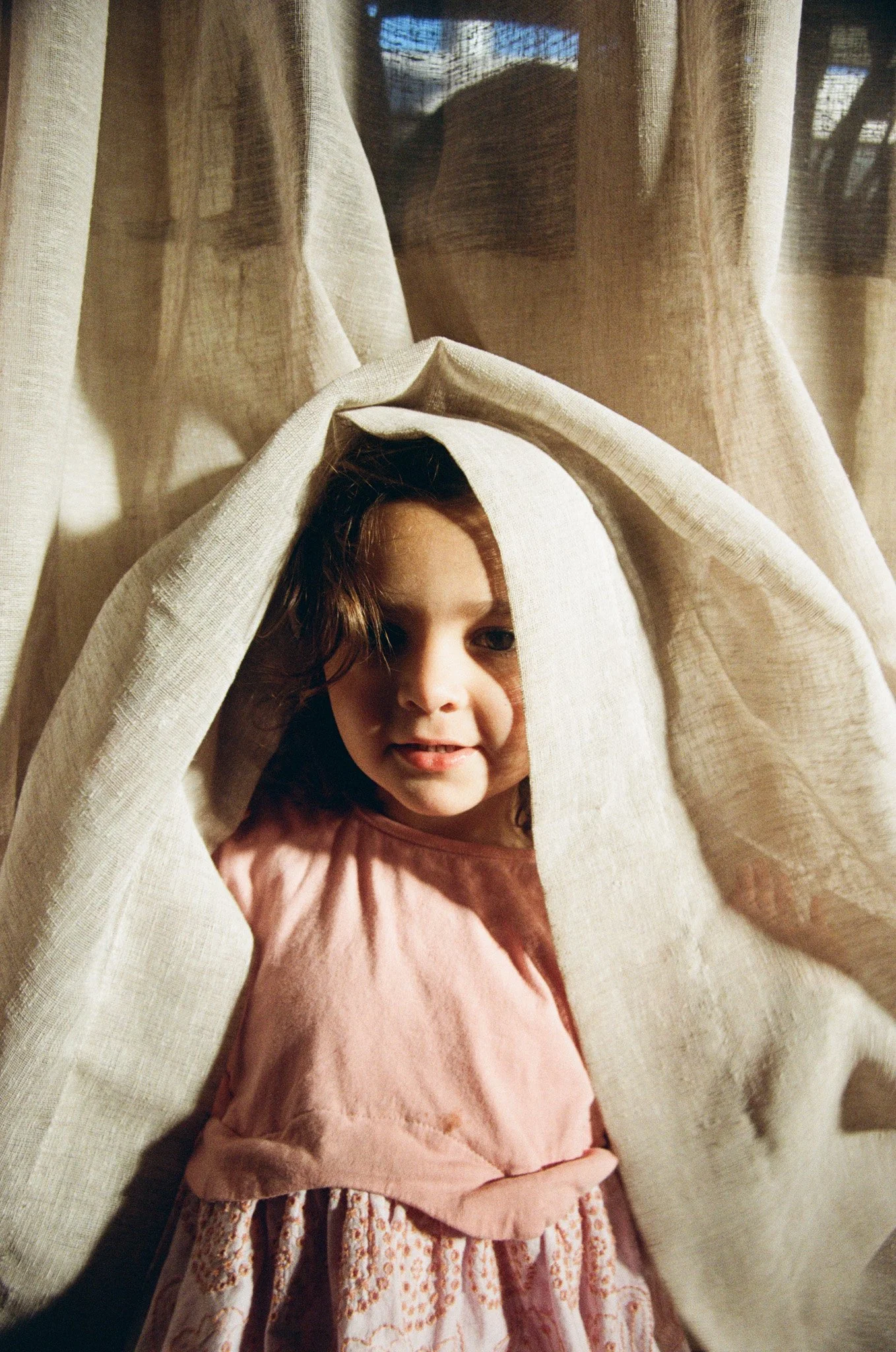 family-portraiture-child-peeking-curtain.jpg