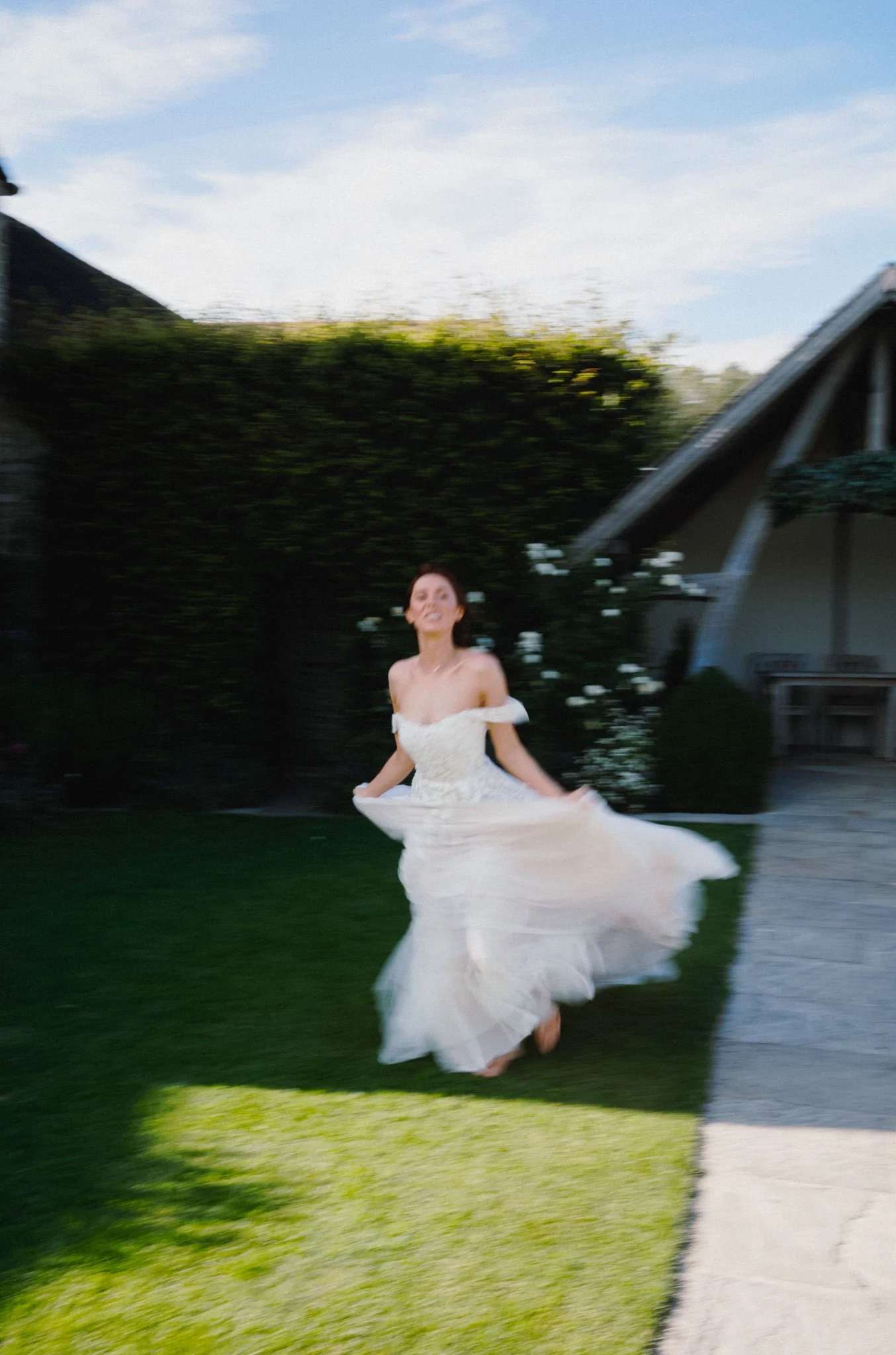 wedding photography of a bride running with a slow shutter at Kingscote Barn