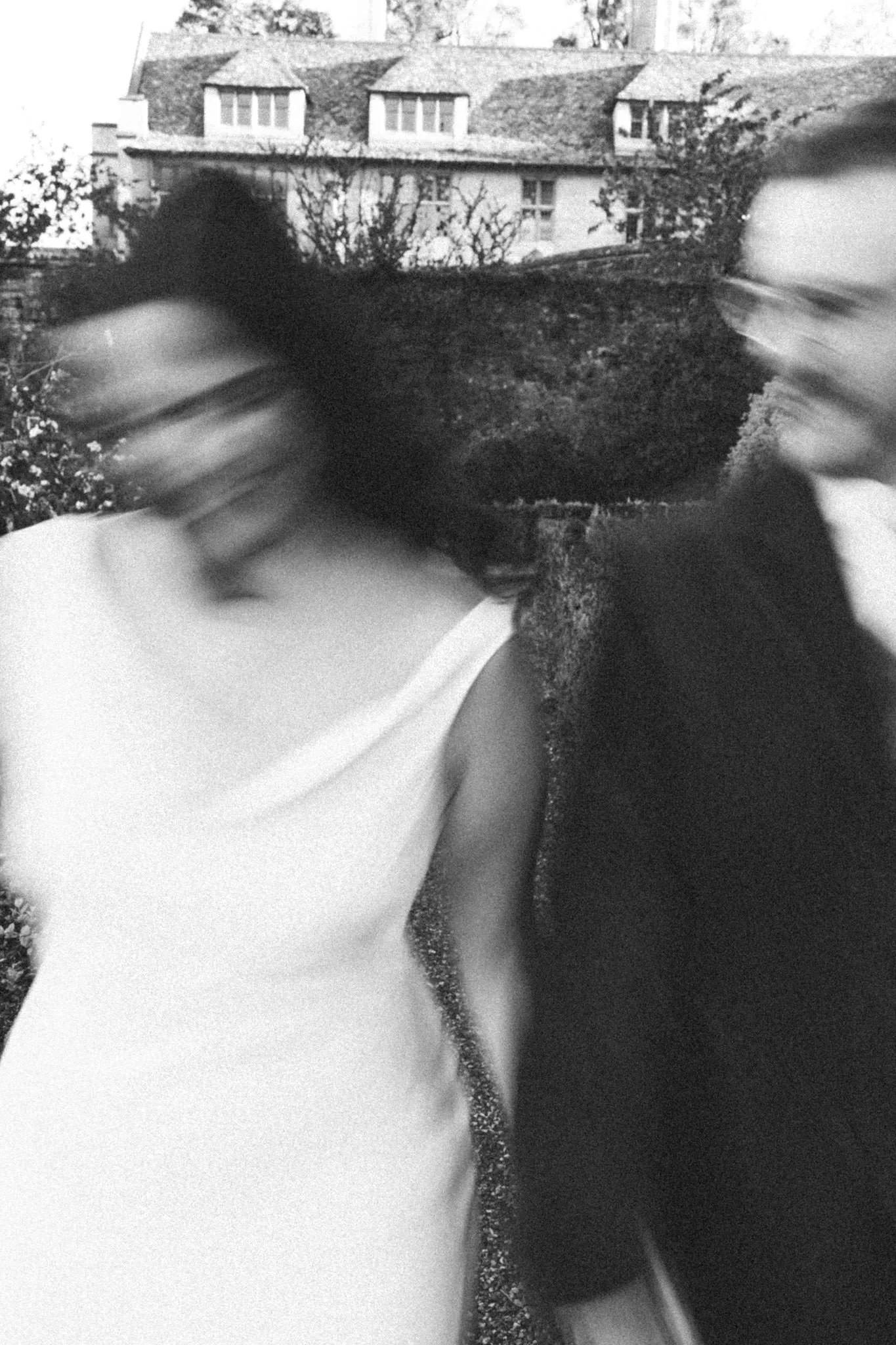 Film wedding photo of a bride and groom with slow shutter walking close to the camera