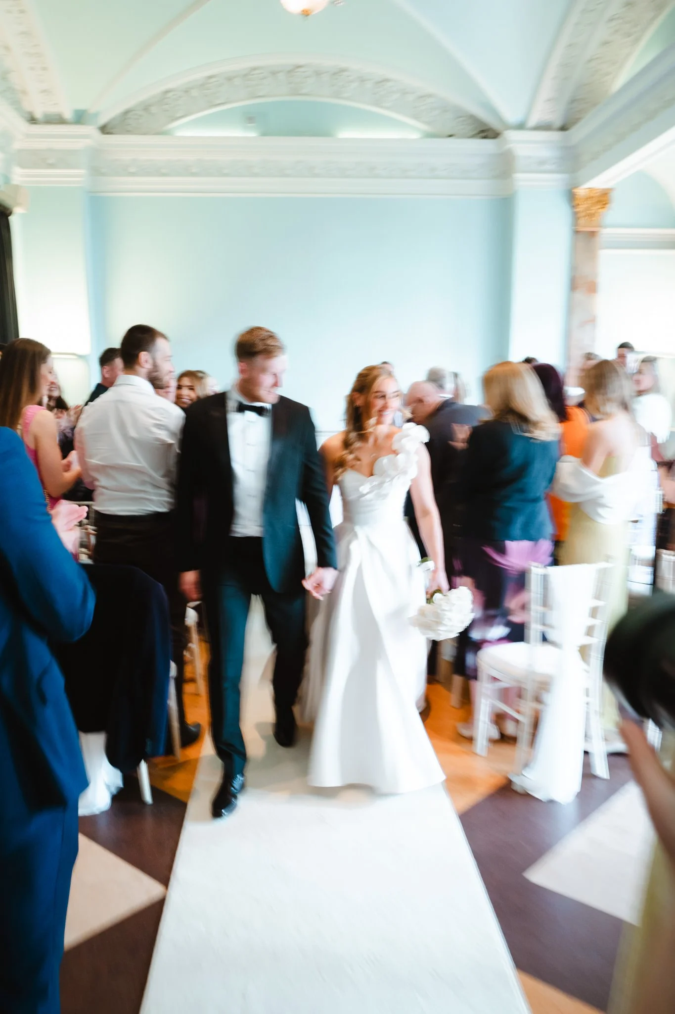 Slow shutter bride and groom walking down the aisle in Cheltenham Town Hall