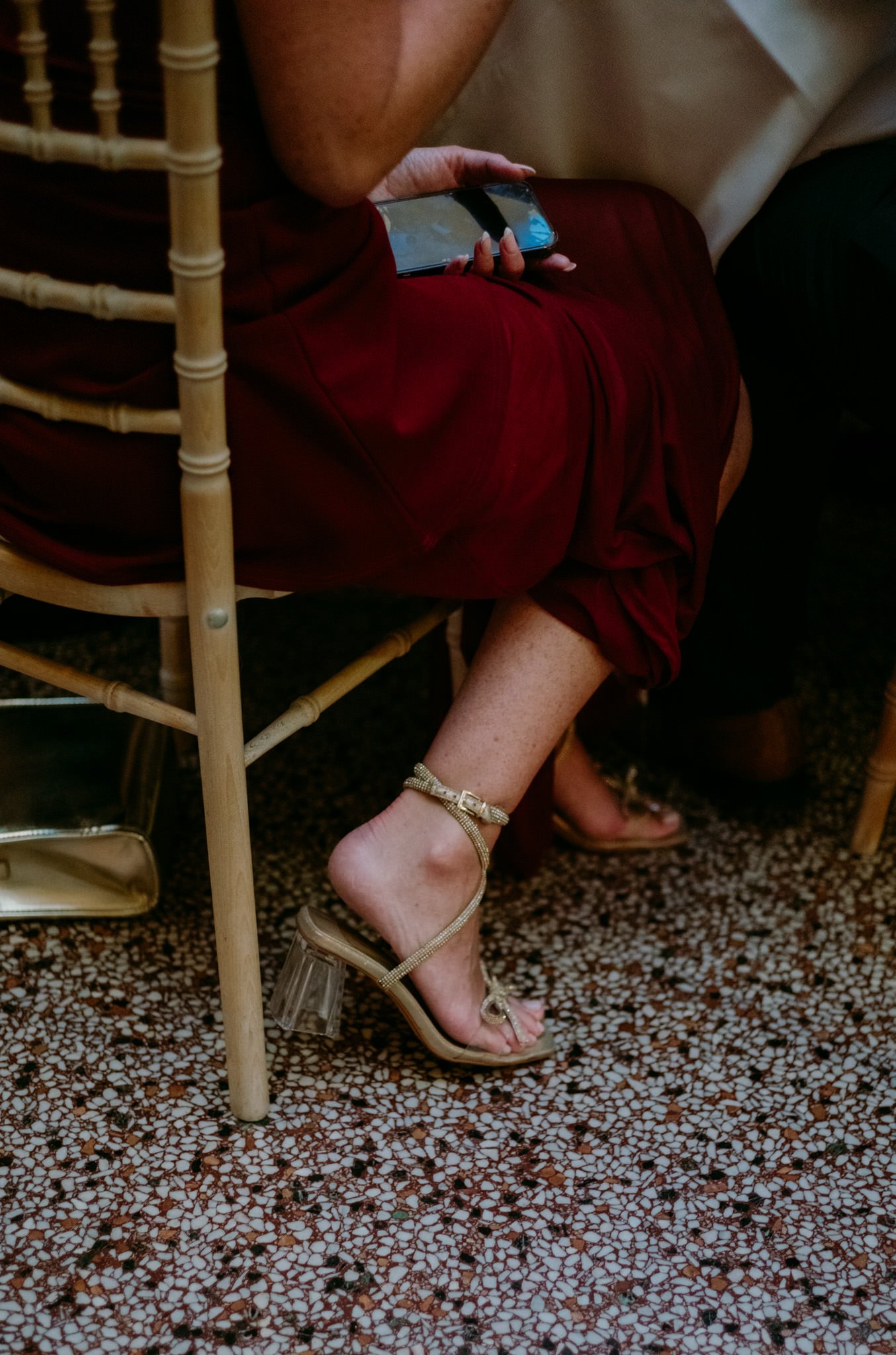Detail of a female guests ankle and shoes at a wedding