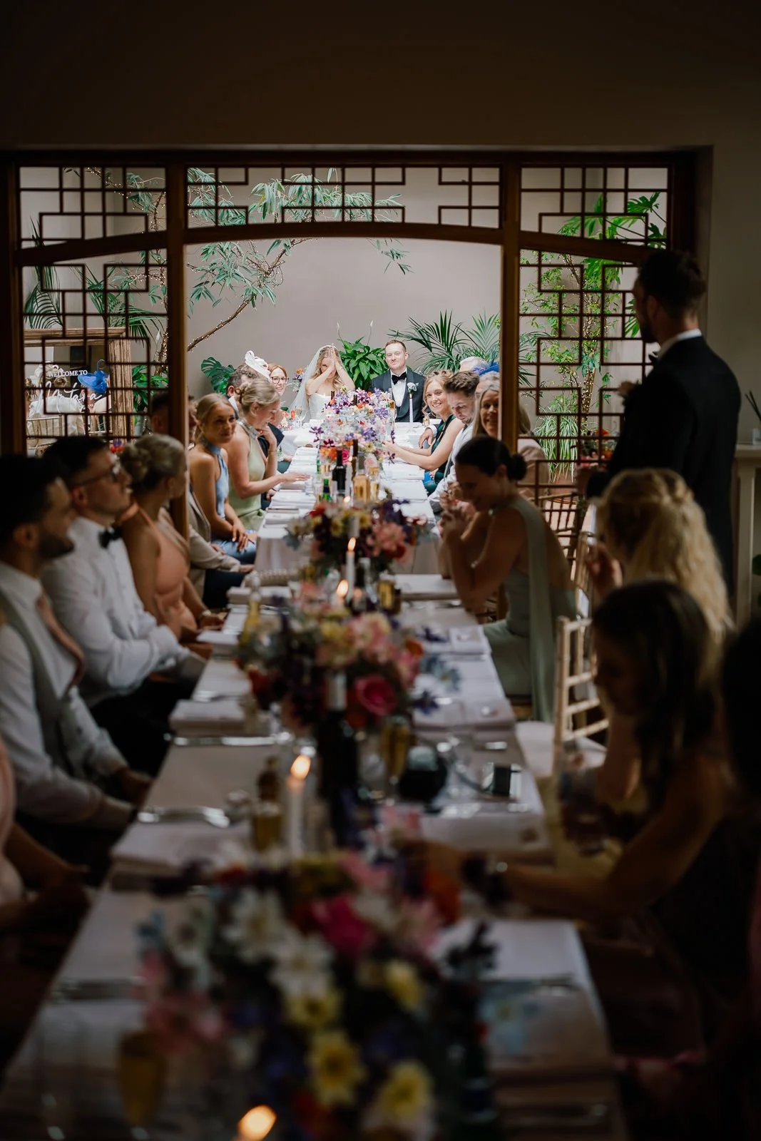 Bride thanking master of ceremonies during wedding dinner speech