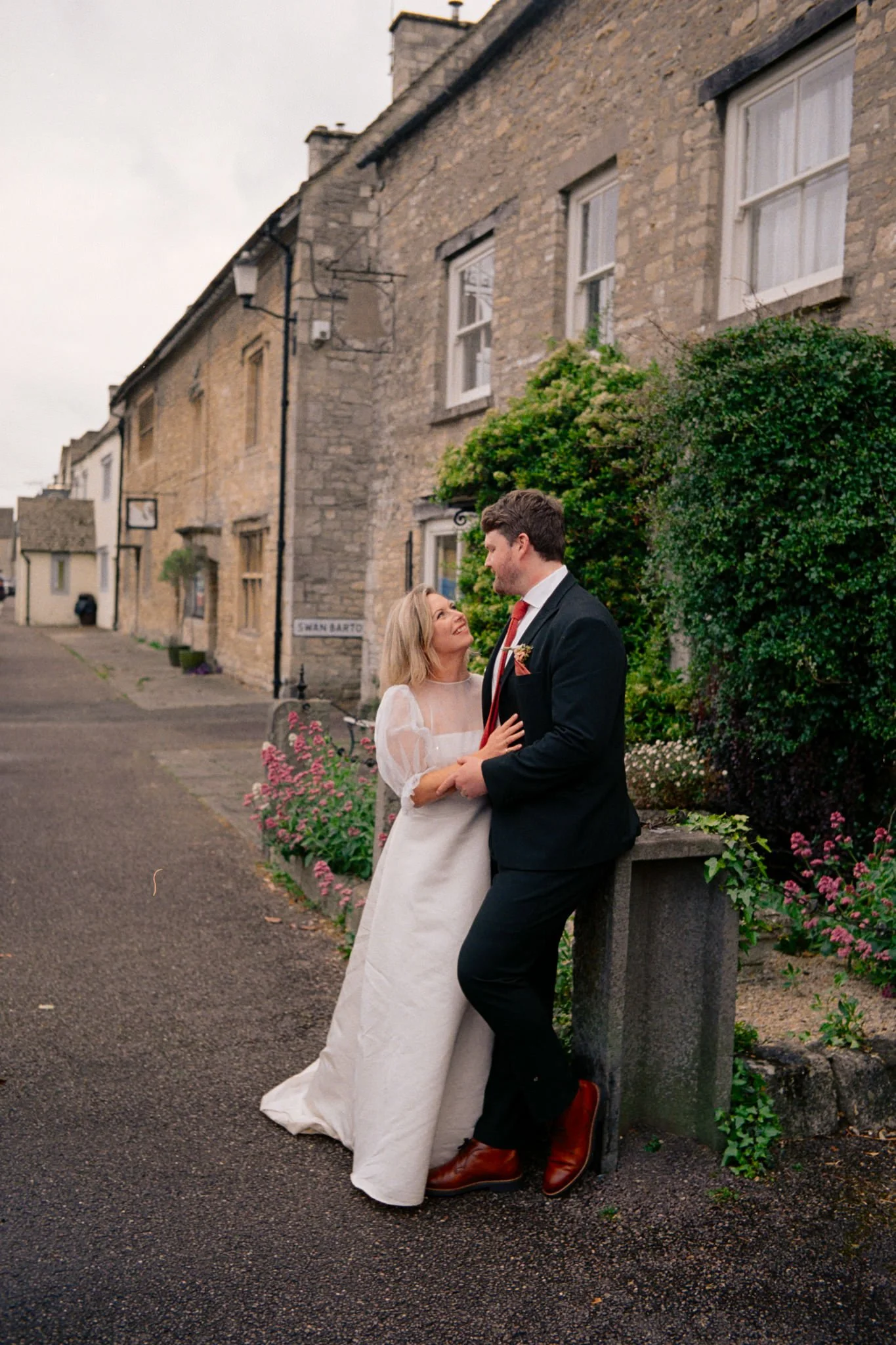 Bride and groom together on a cotswold street at their wedding