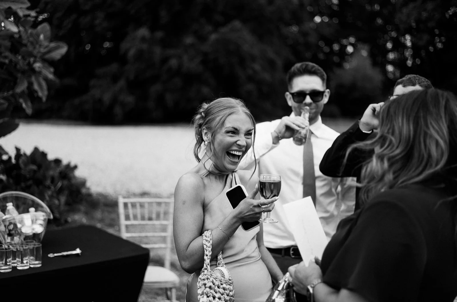 Guest laughing on dancefloor, black and white wedding photography