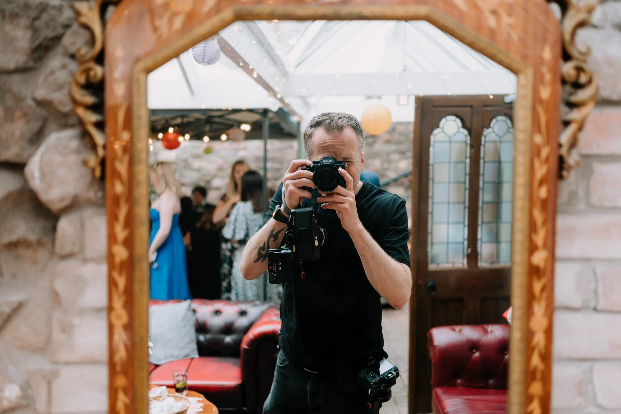 wedding photographer taking a seflie in the mirror at the radnor rooms in bristol with a Sony A7iv and a Nikon F3