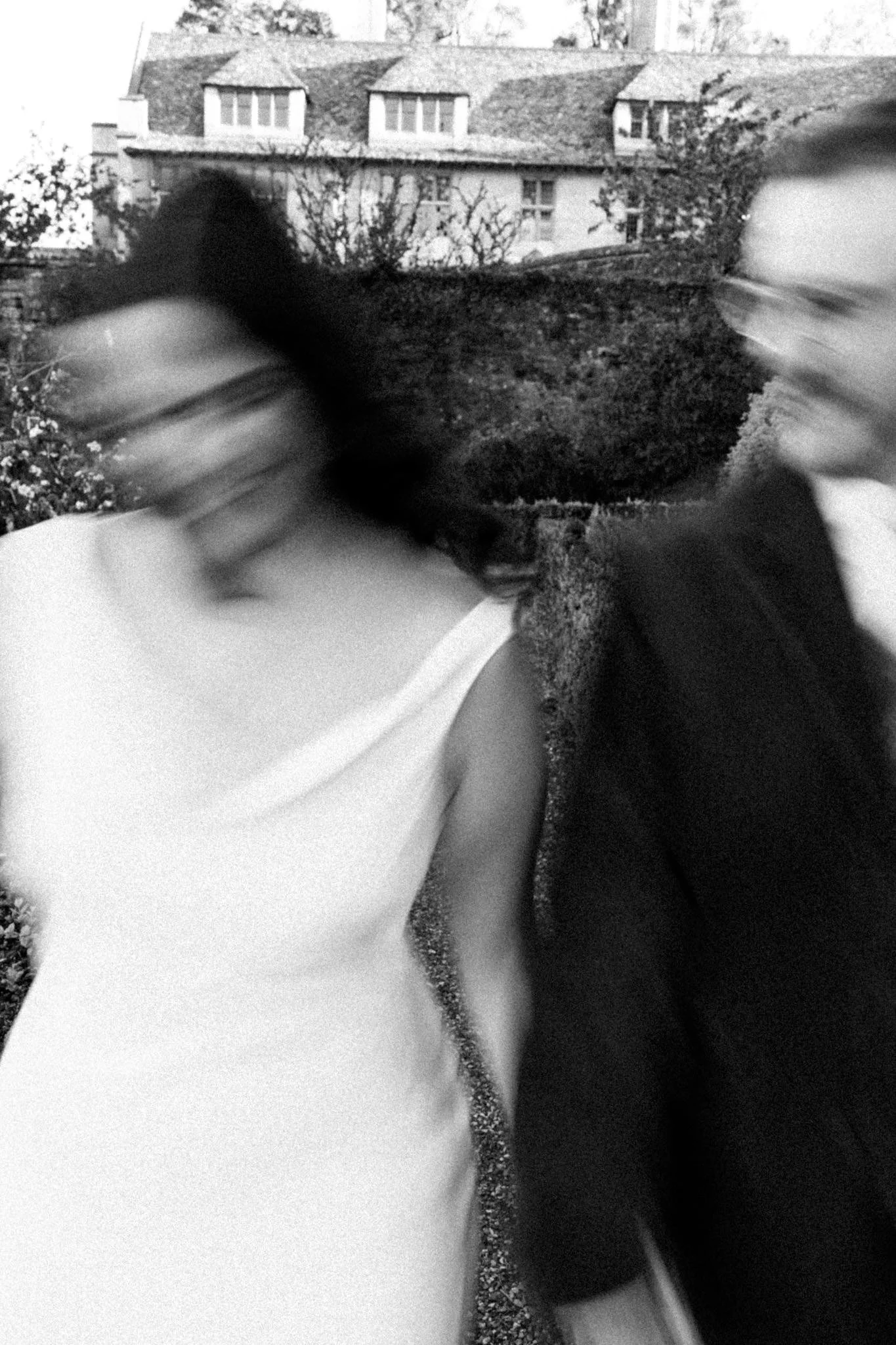 wedding photography of the bride and groom walking toward the camera with motion blur in black and white