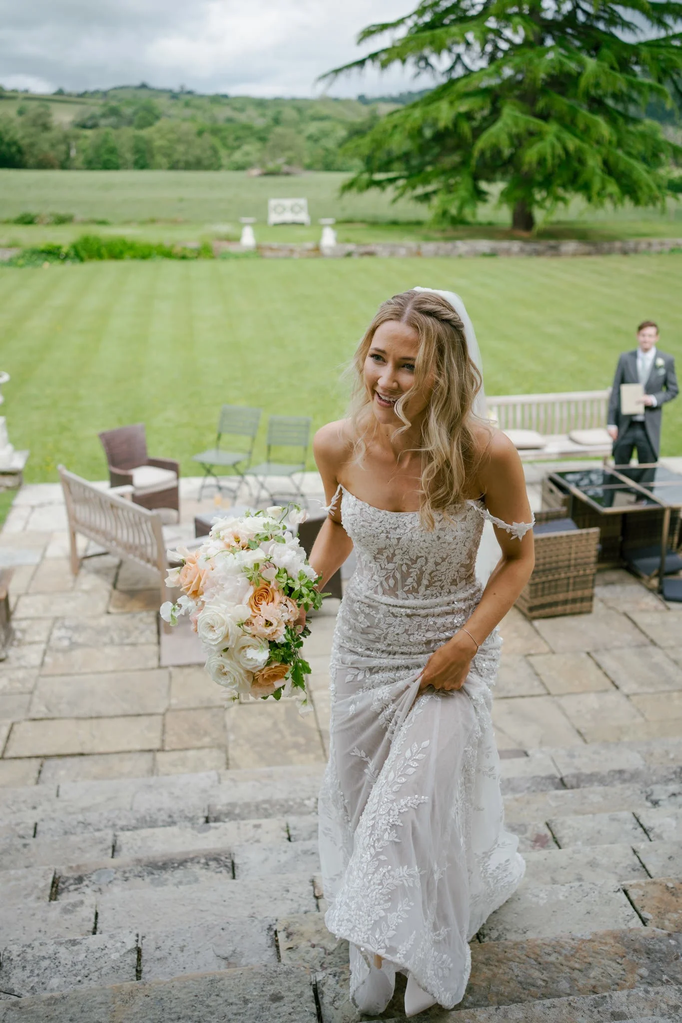 Beautiful bride walking up some steps at Llangoed Hall in Wales