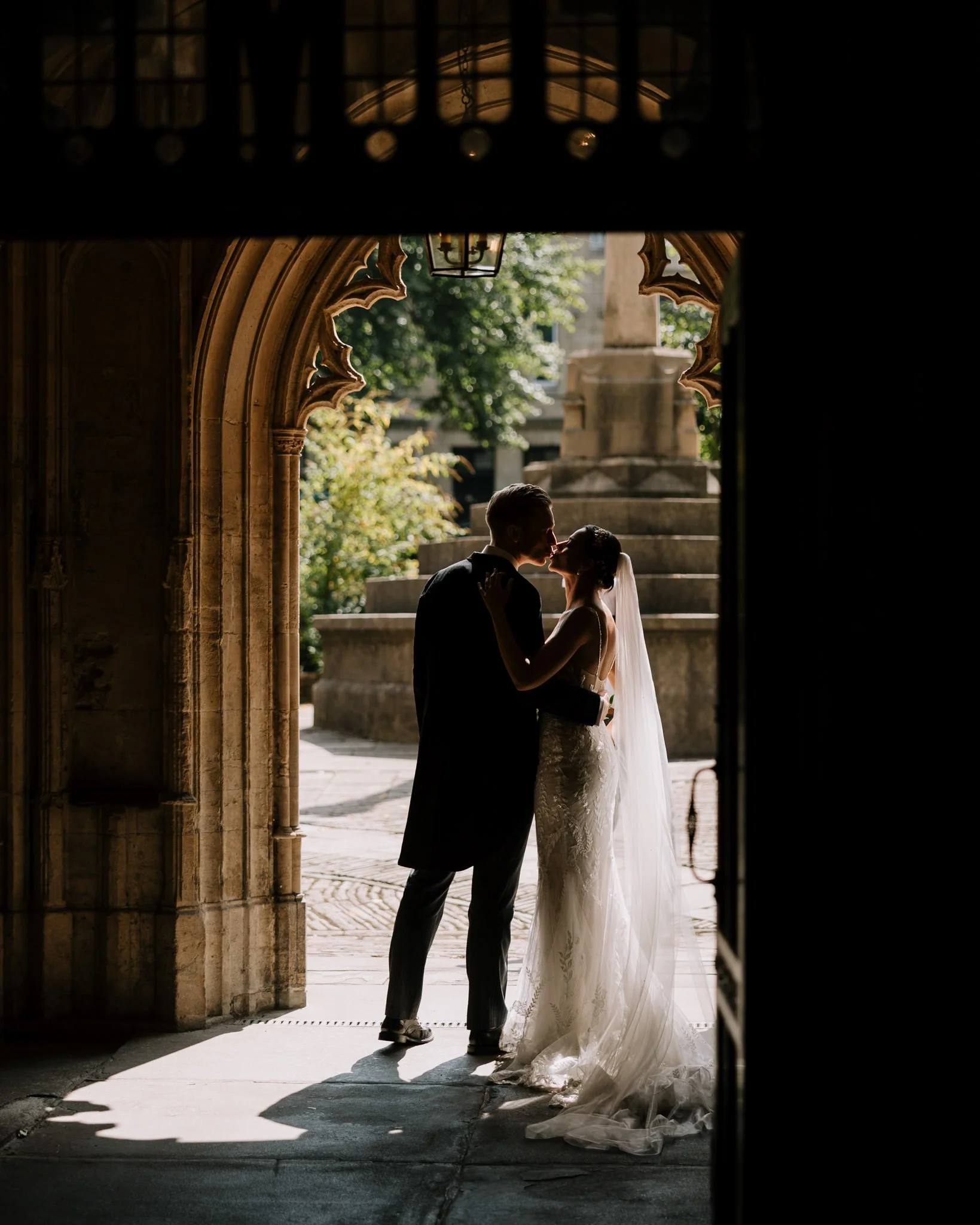 Bride and groom share a kiss outside St Mary Redcliffe church in Bristol