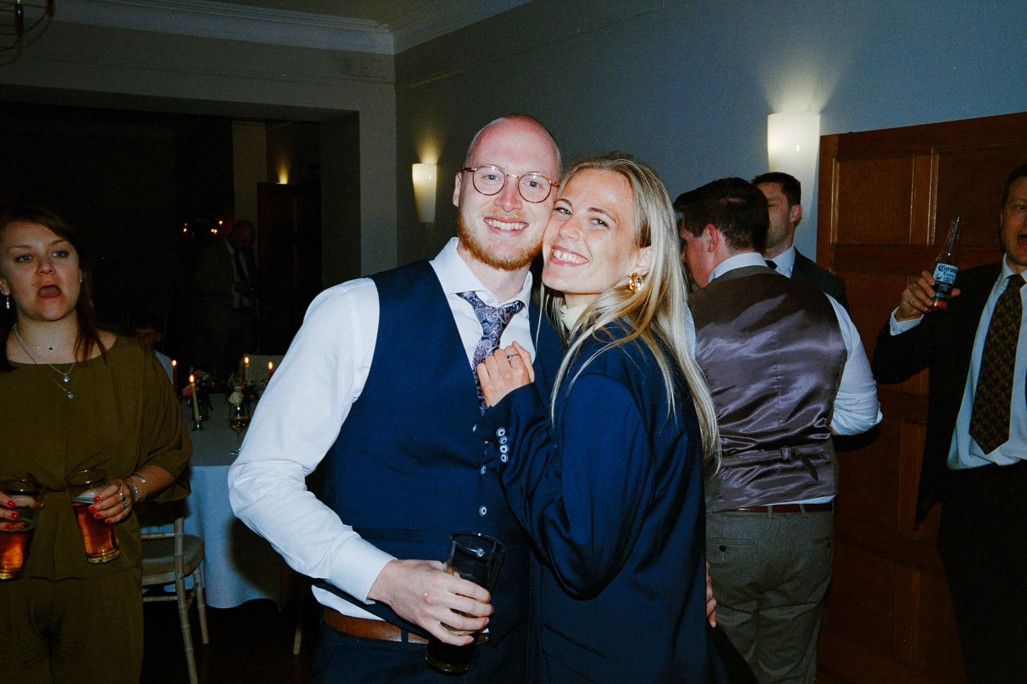 Couple cuddling on the dance floor, both are wearing blue