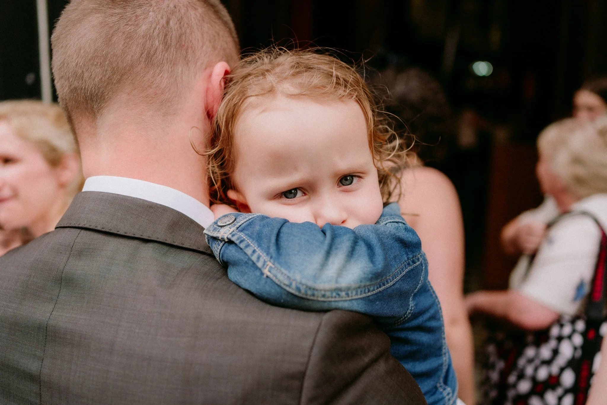 A small child looking soulful at a wedding in Bristol