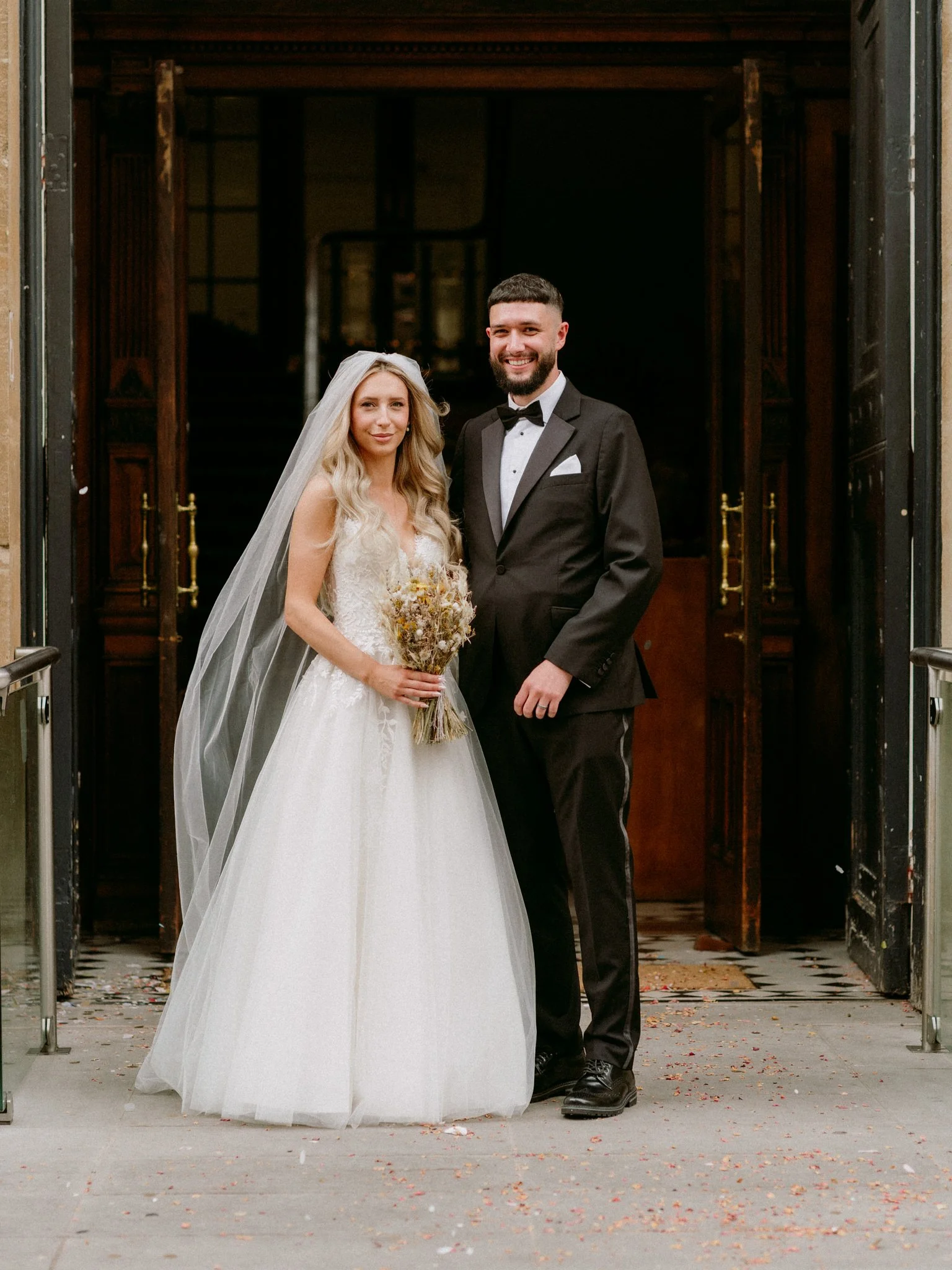 Bride and Groom pose for a photo at their wedding outside Bristol Register Office