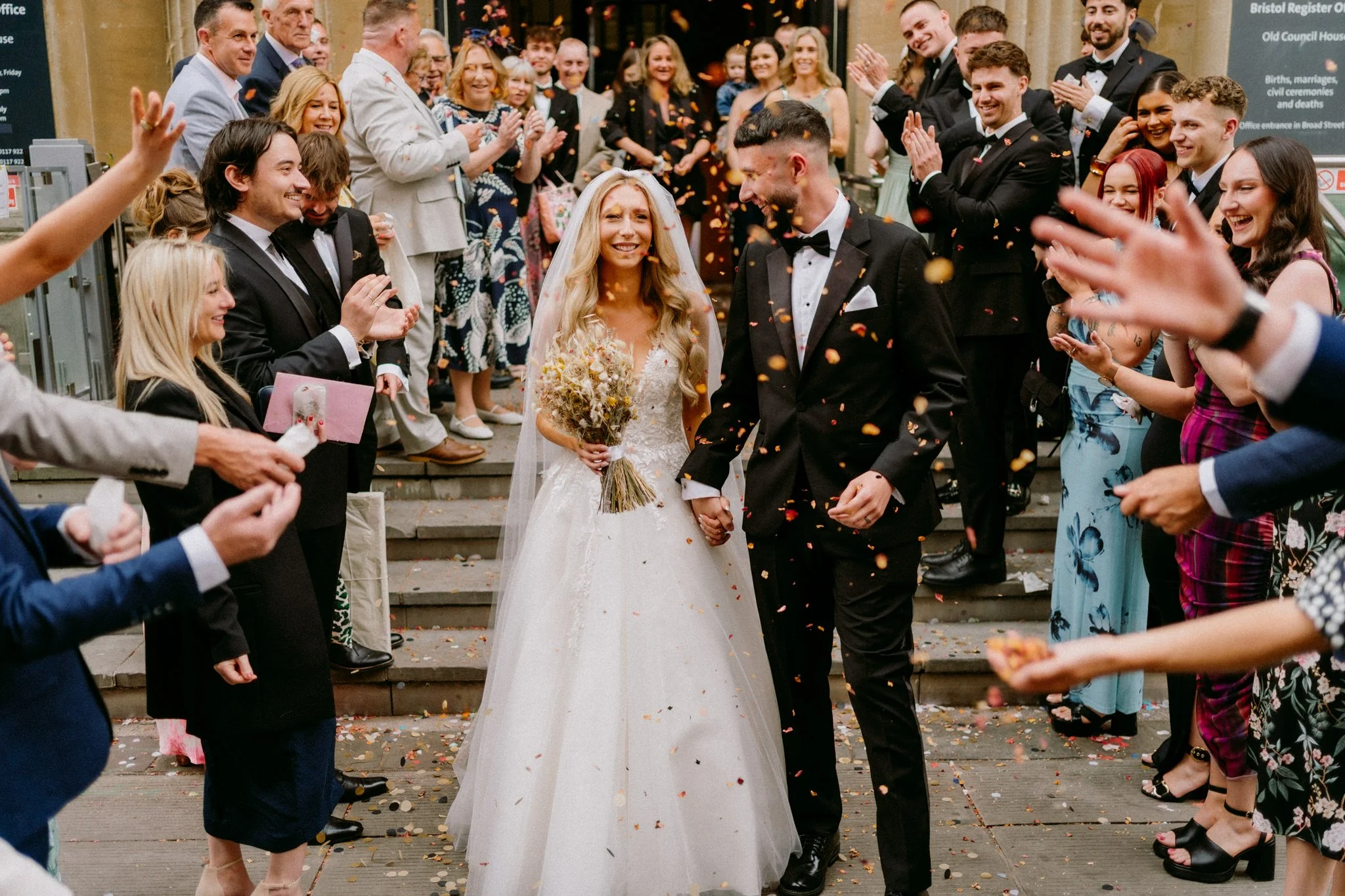 The Bride and Groom during a confetti throw at Bristol Register Office