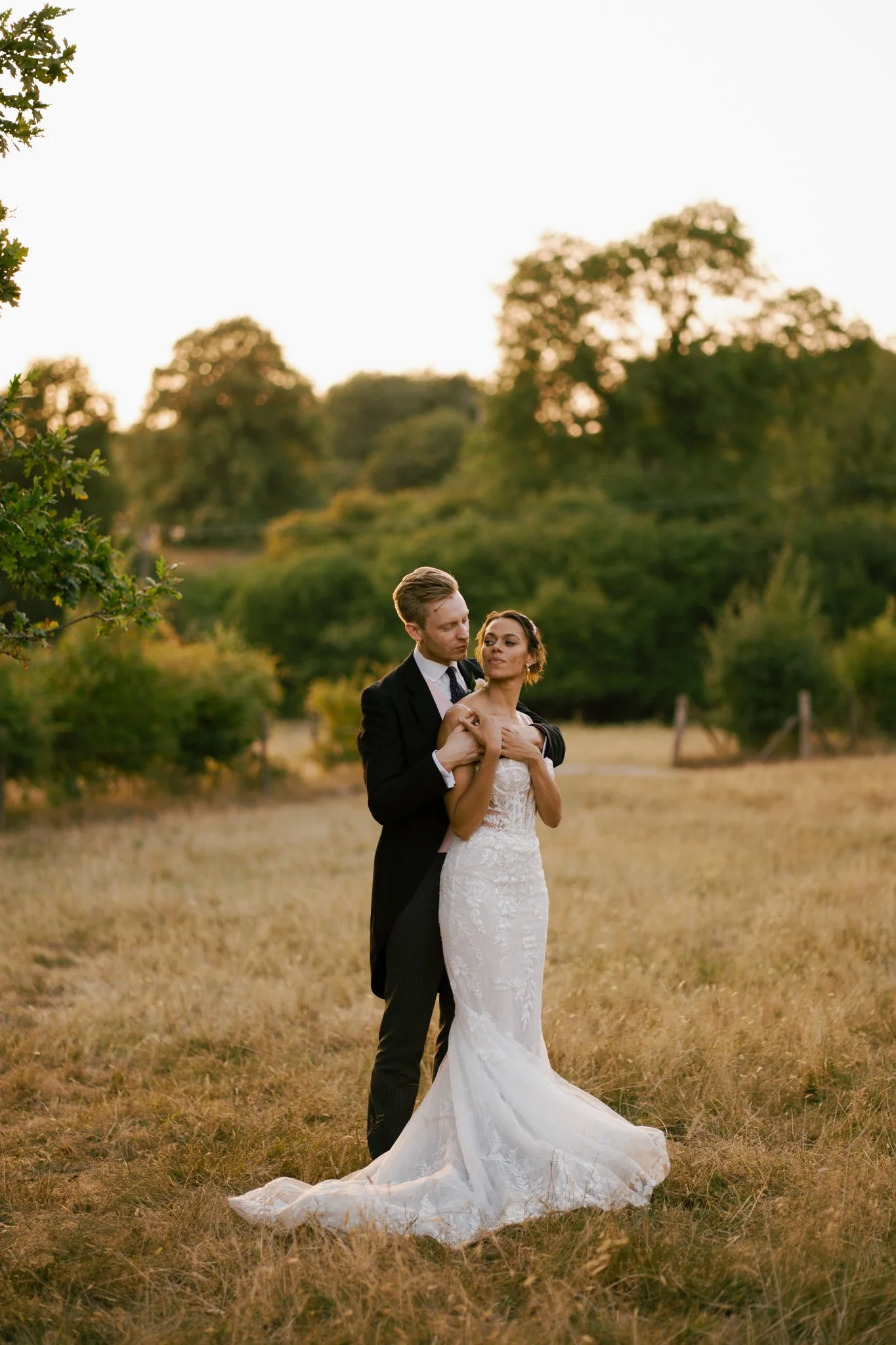 White groom and black bride in the sunset at Folly Farm in Bristol