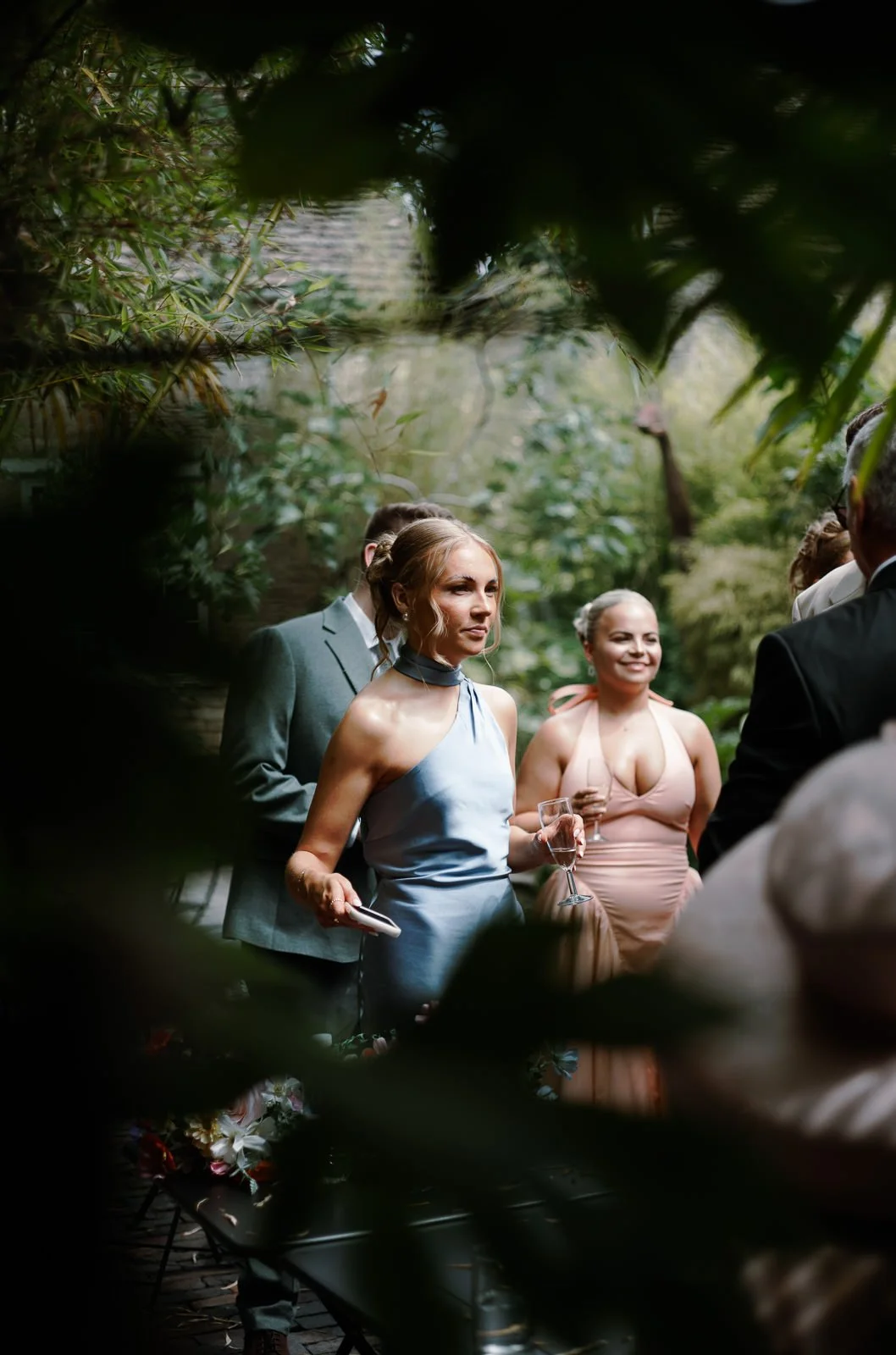 Guest photographed through window framed by plants, Matara Cotswolds