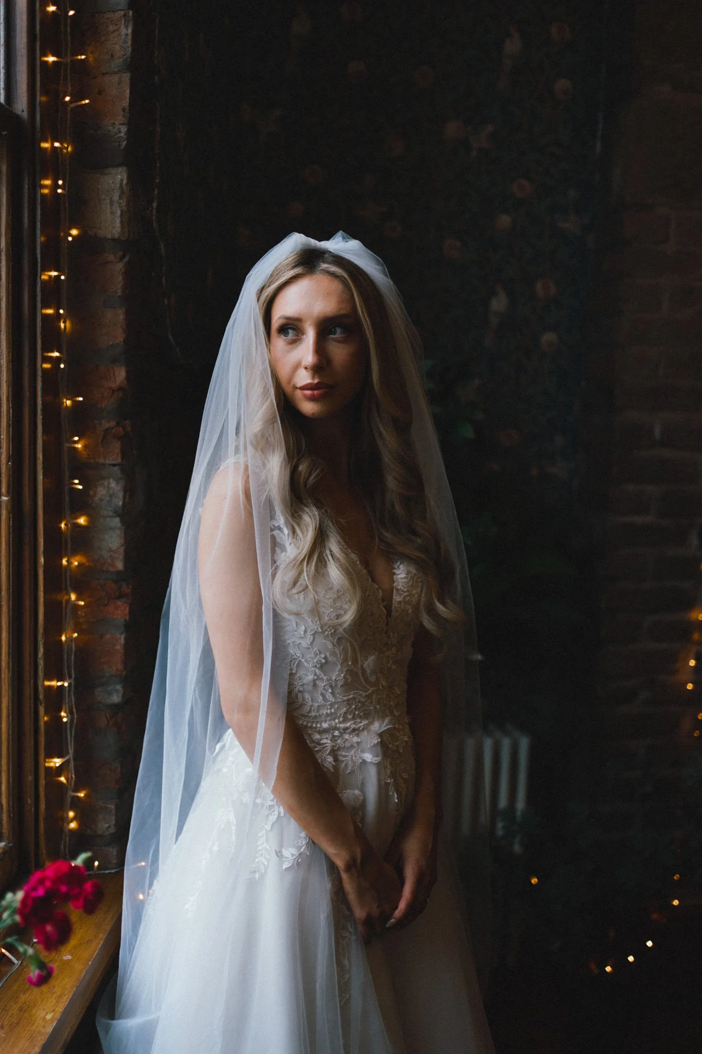 Bride portrait at The Randor Rooms in Bristol, she is blond and very beautiful, standing by a window