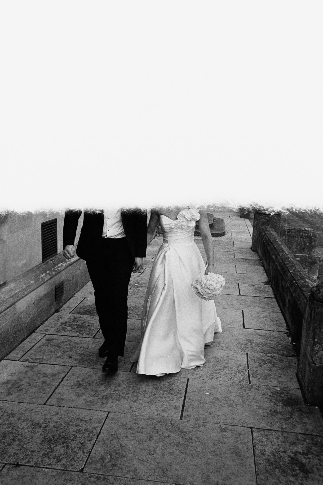 First shot on a roll of film with heavy light leak, bottom half is a couple's legs at their wedding day