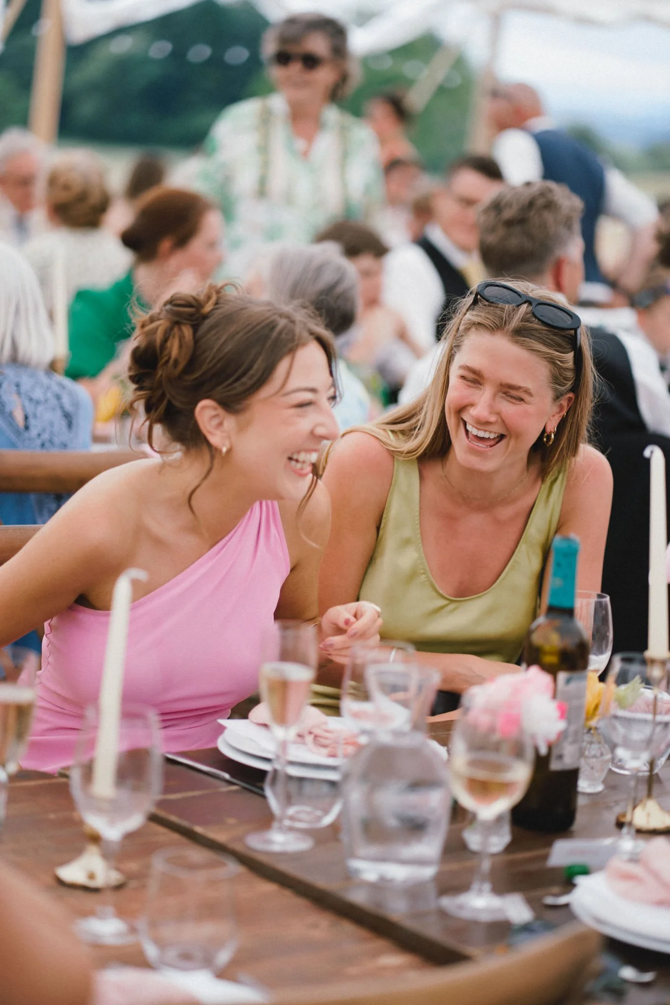 wedding photography of two beautiful women laughing in bright dresses