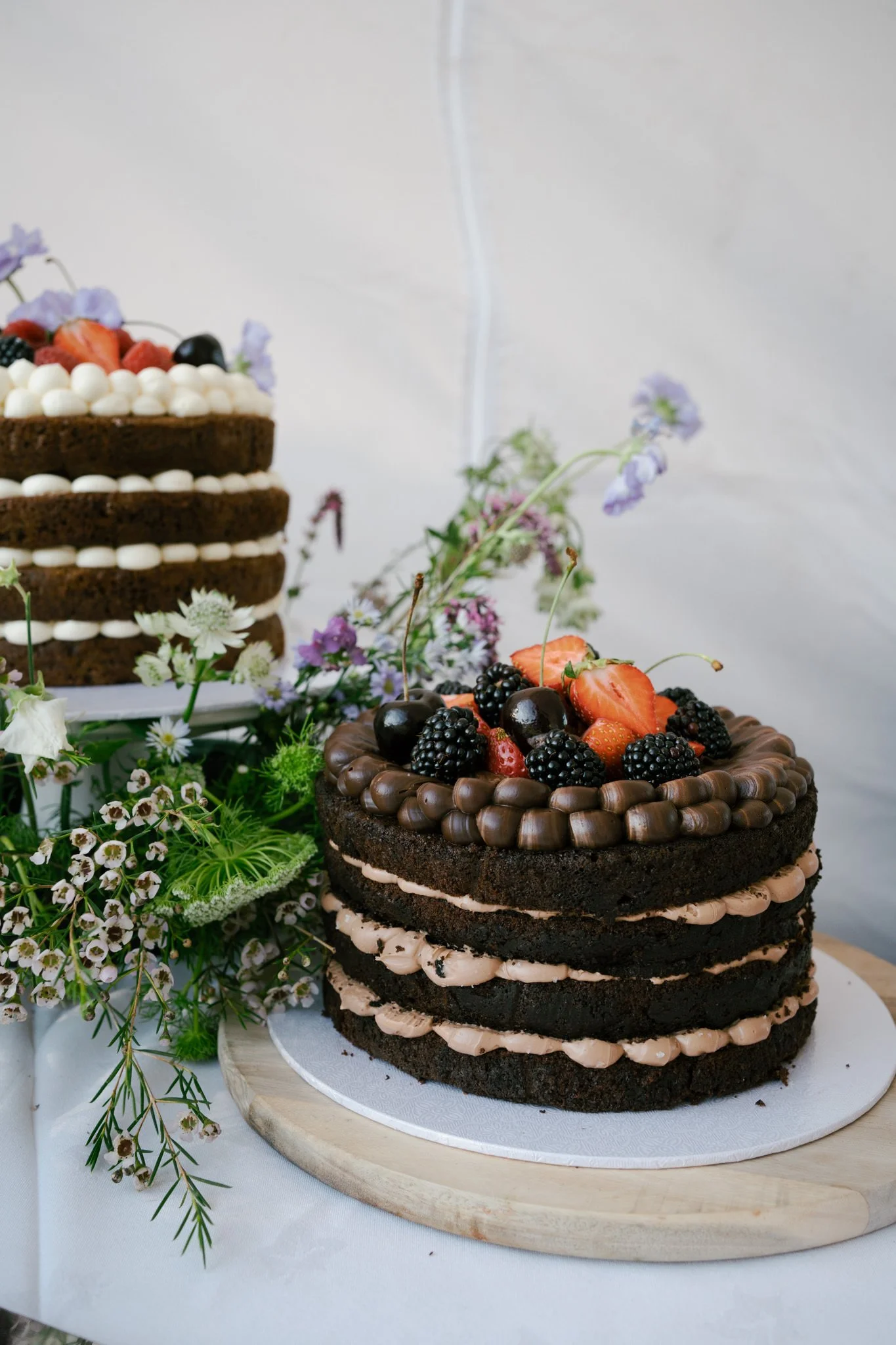 Home made wedding cake details with flowers and fresh fruit