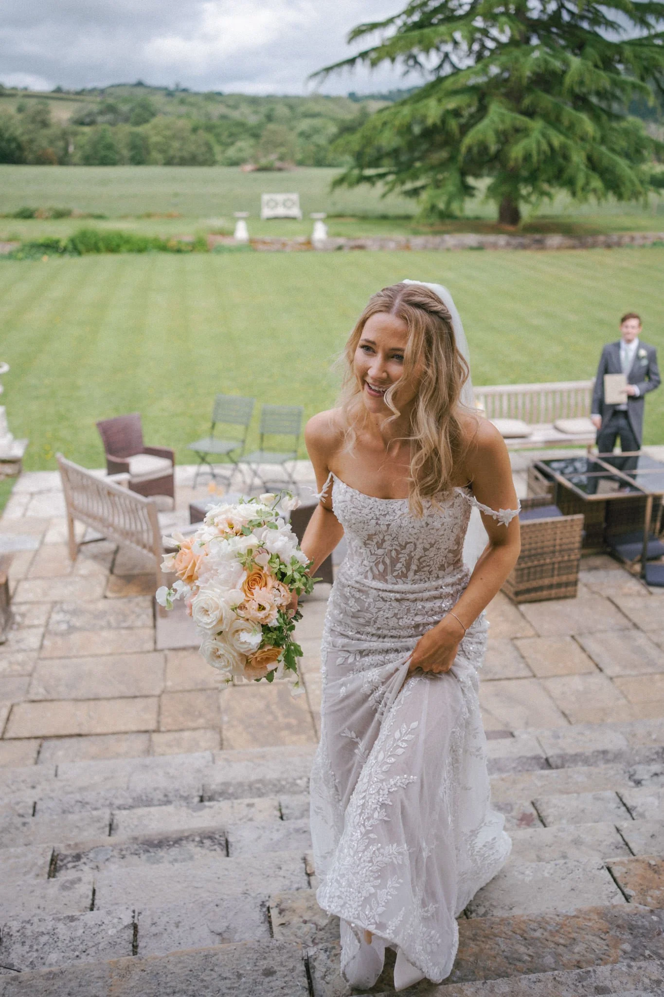 wedding photography of a bride in a beautiful lace dress walking up some stairs