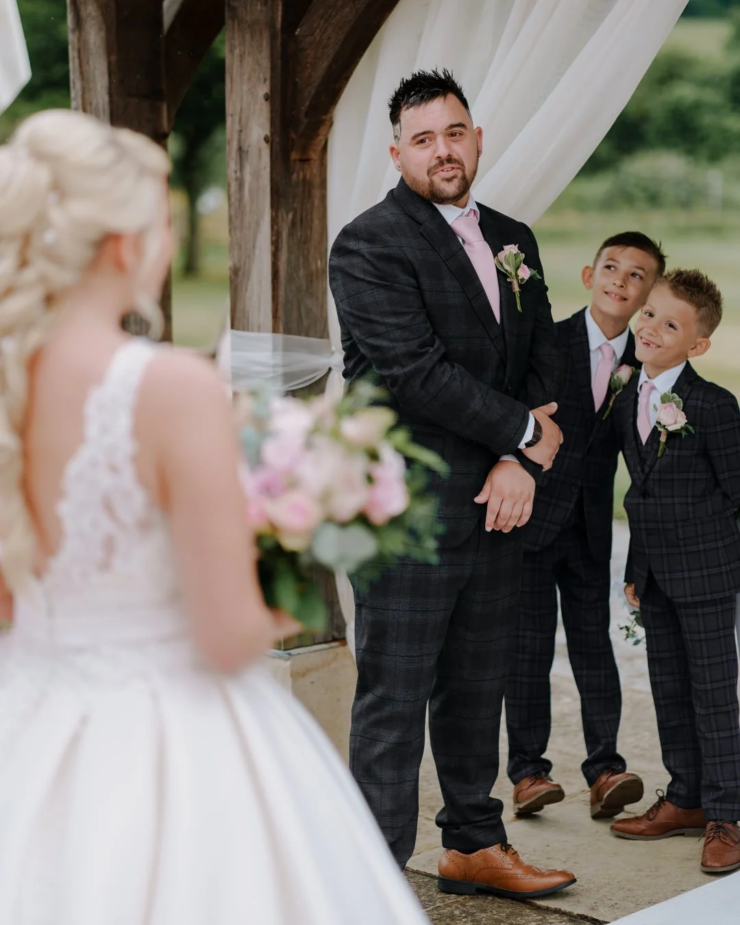 Bowood house wedding photography bride and groom with sons looking on