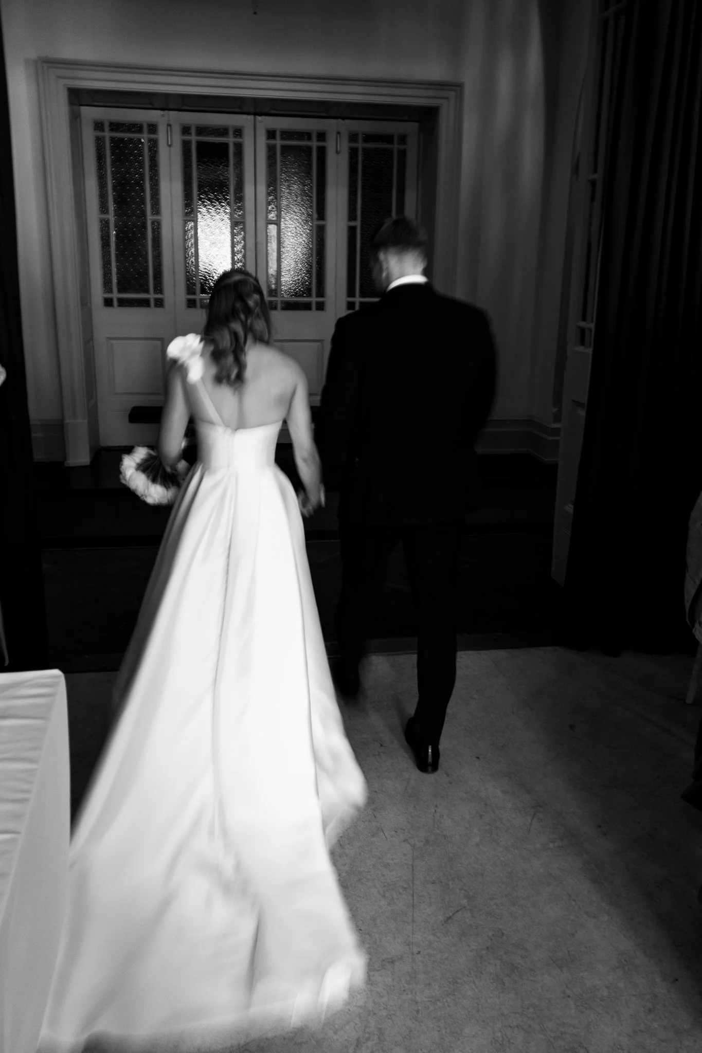 Slow shutter of bride and groom leaving ceremony at Cheltenham Town Hall