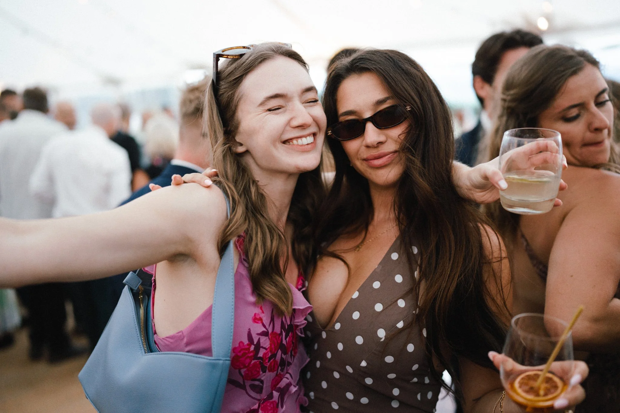 wedding photography of two beautiful female guests having fun on the dancefloor